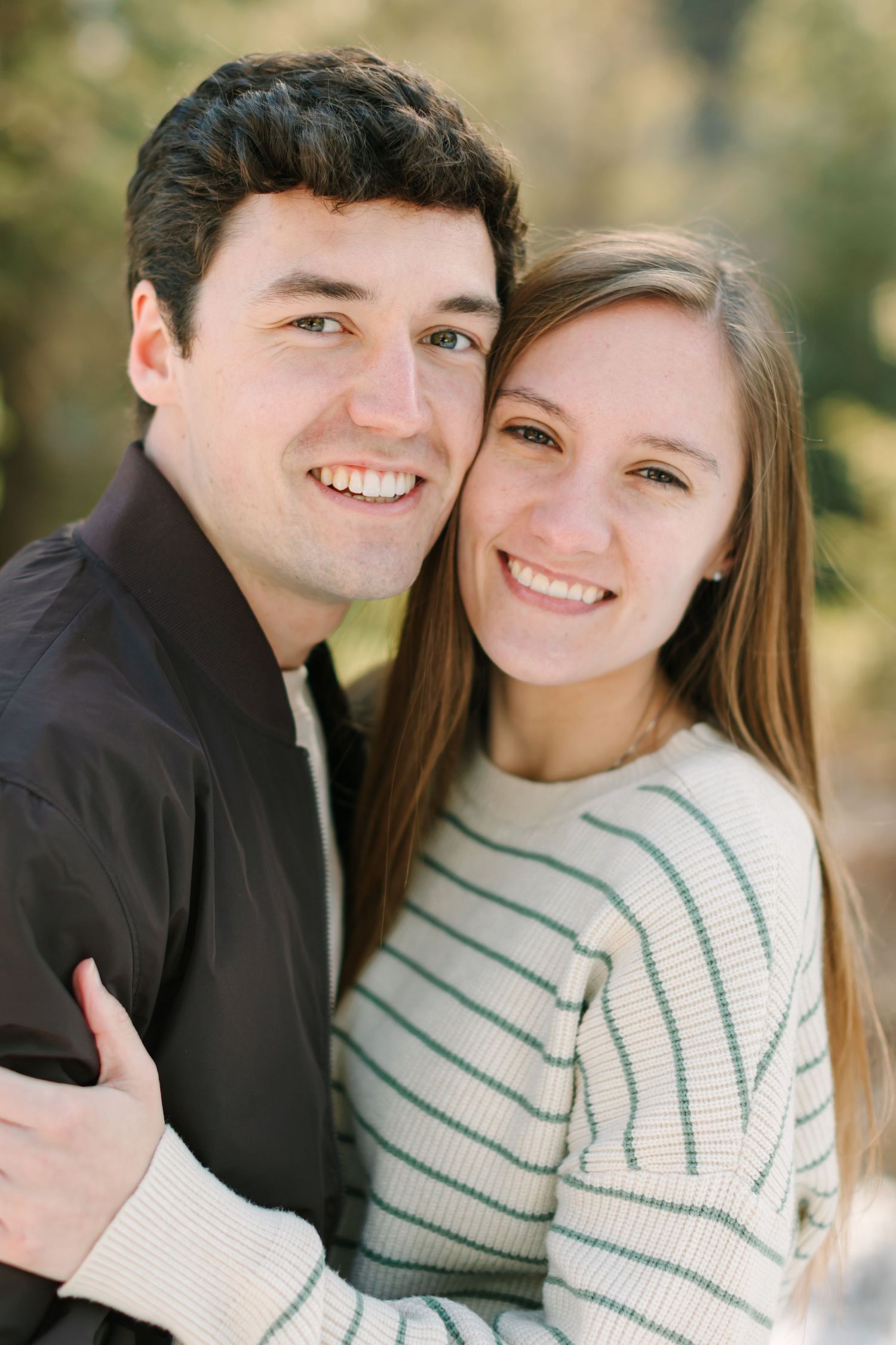 A couple in black and white sweaters share tender moments in a series of romantic outdoor photos.