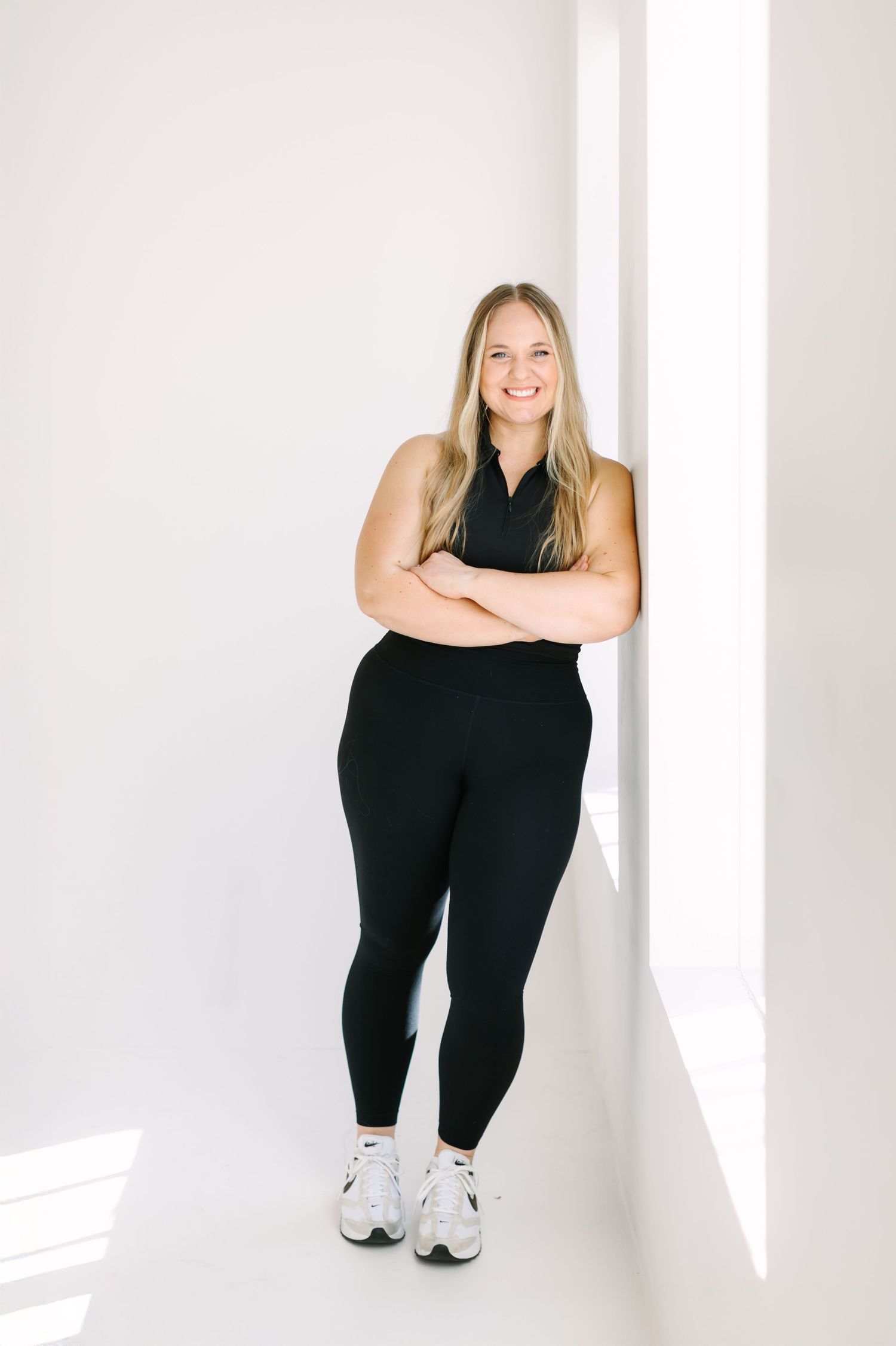 A figure in black athletic wear and white sneakers poses against a white backdrop in four different positions.