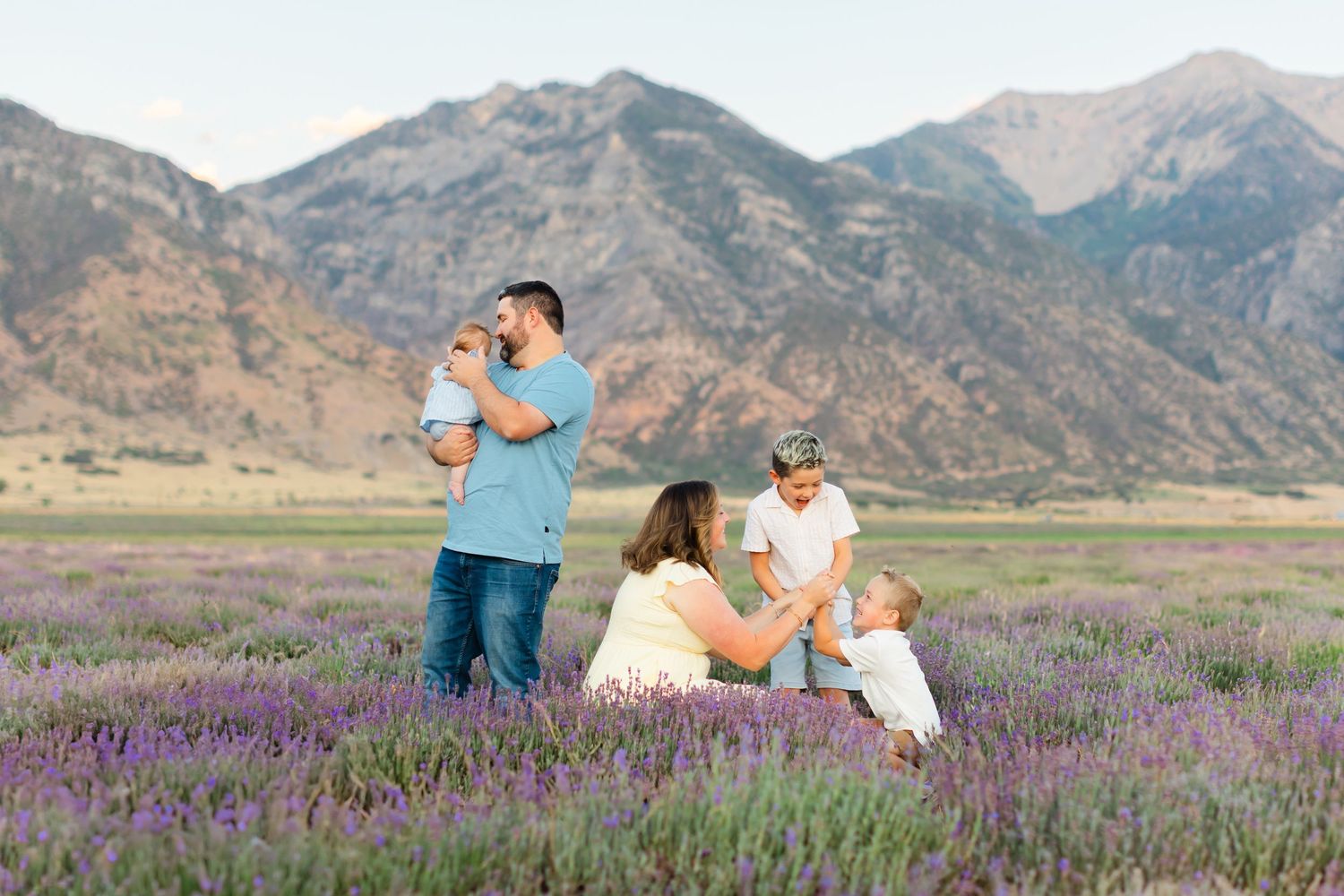 A family poses for their family photography mini session at the young living lavender farm in Mona, Utah.