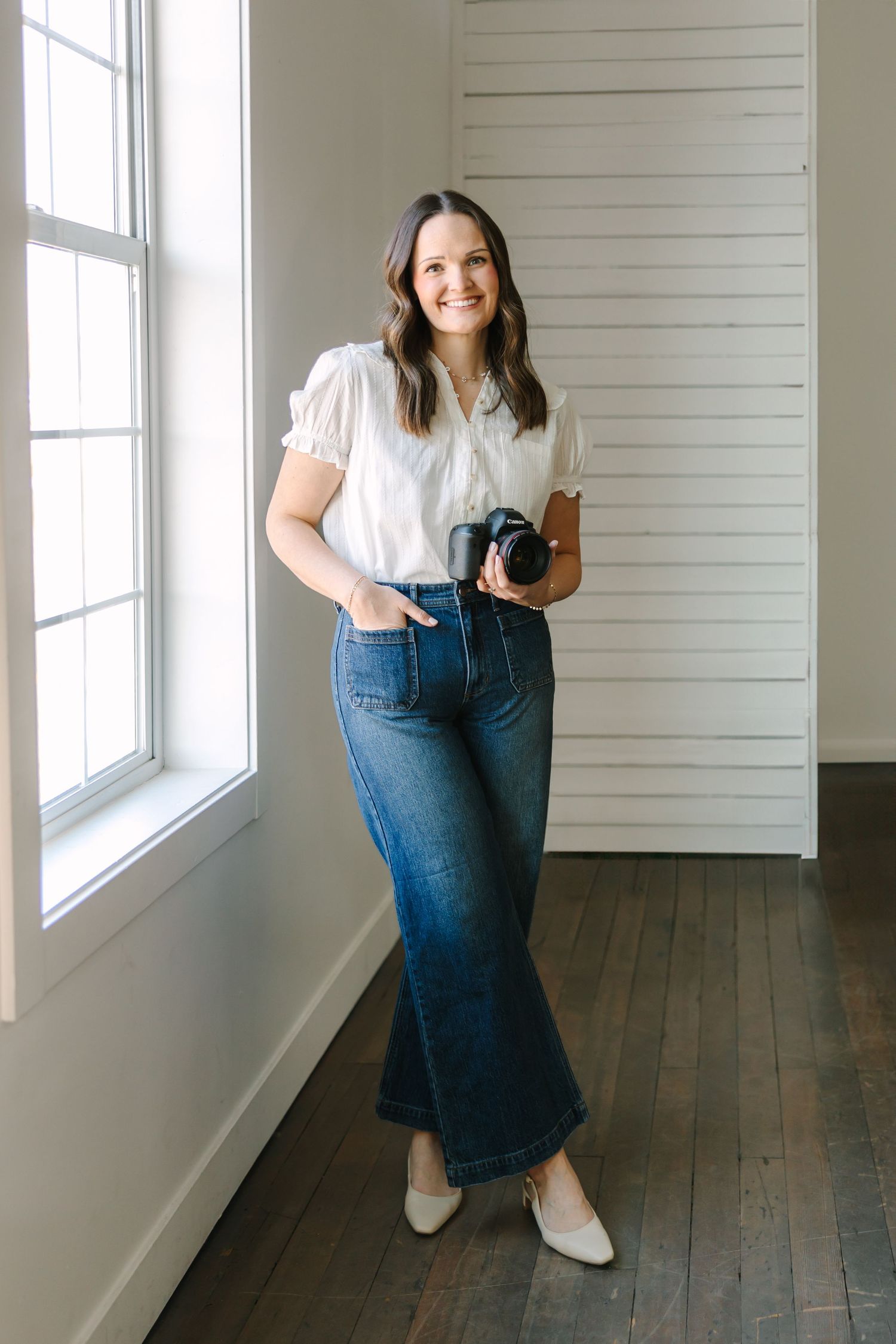 A series of minimalist portraits against white shiplap walls and wooden floors in a bright interior space in Utah County.