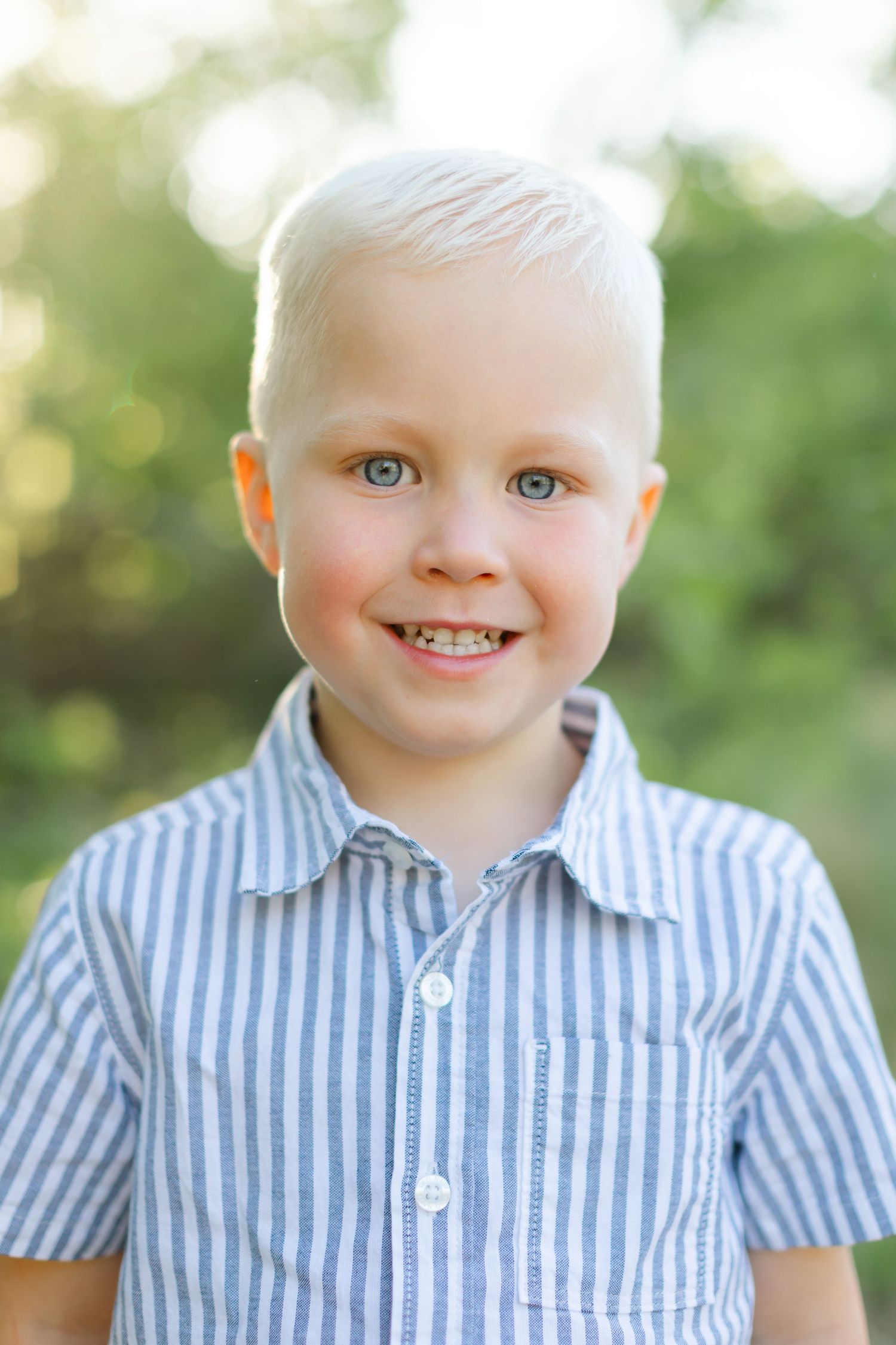 A series of four close-up photos showing a child wearing a blue and white striped button-down shirt against a blurred outdoor background.