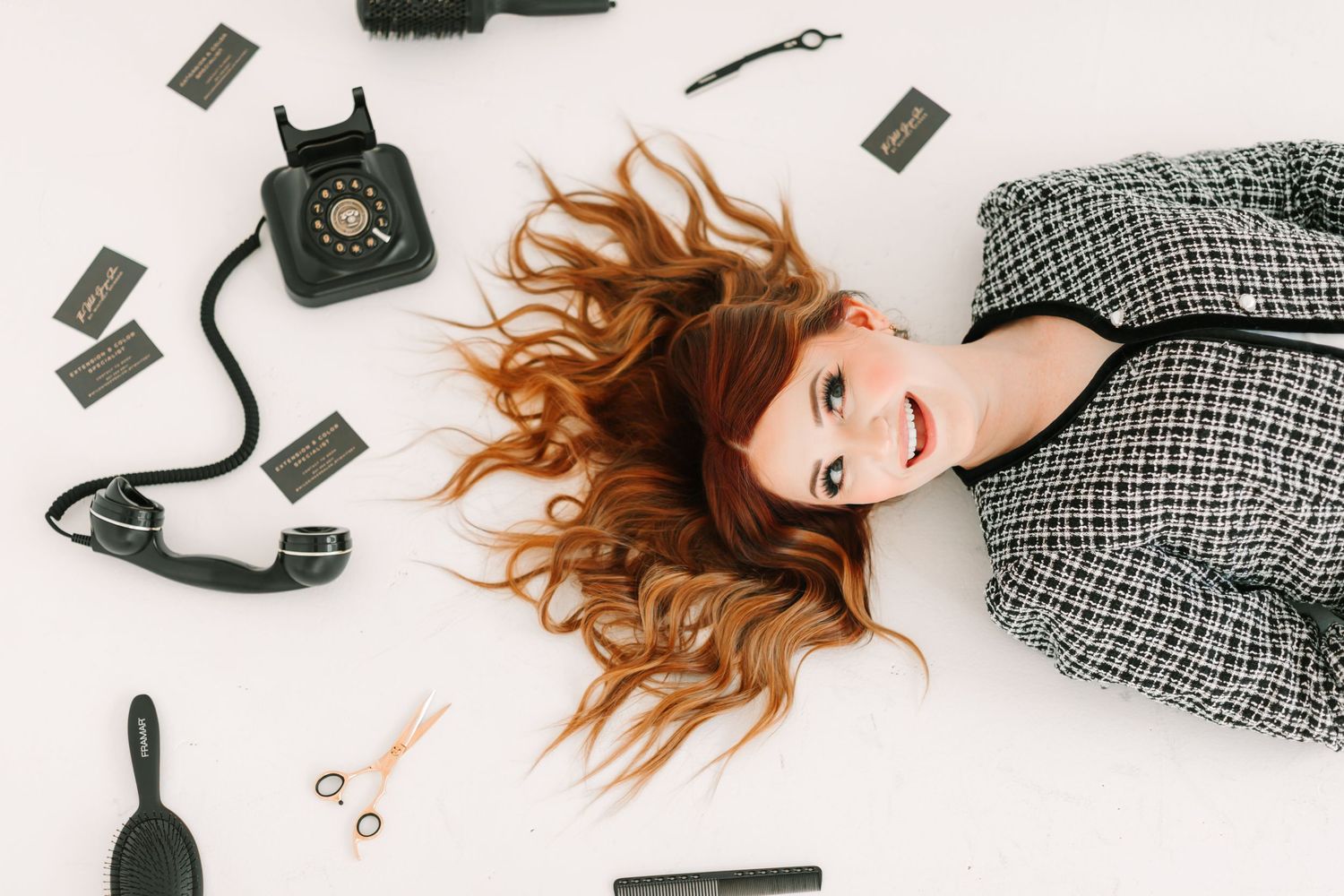 A flatlay composition of fashion accessories including handbags, shoes and scattered items on white background.