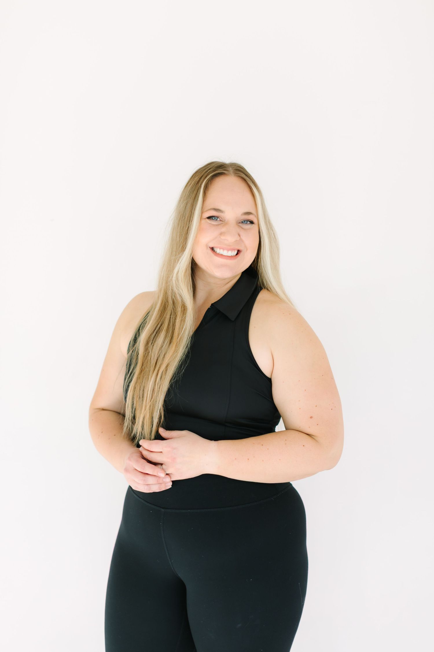 Three photos of a woman in black activewear posing confidently against a white background.