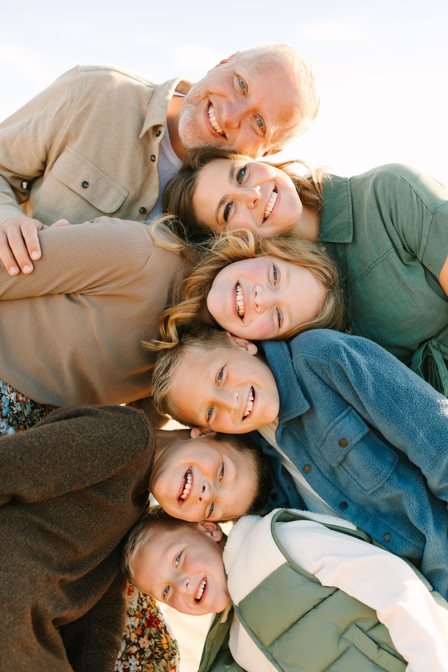 A series of candid overlapping photos showing people lying down and smiling together in casual clothing.