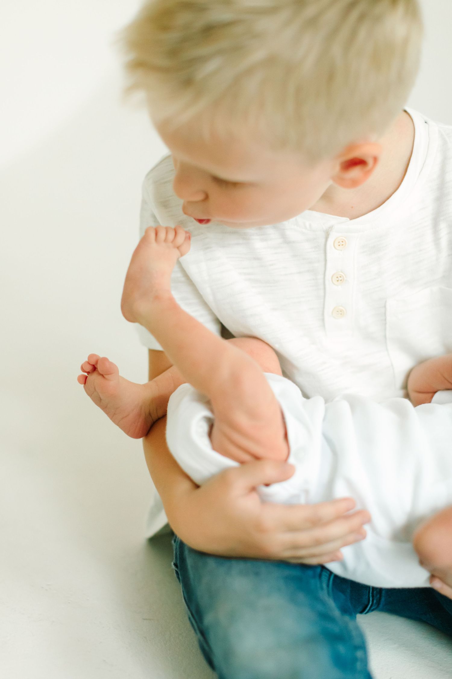 A sequence showing someone in a white shirt and jeans leaning over and hugging themselves.