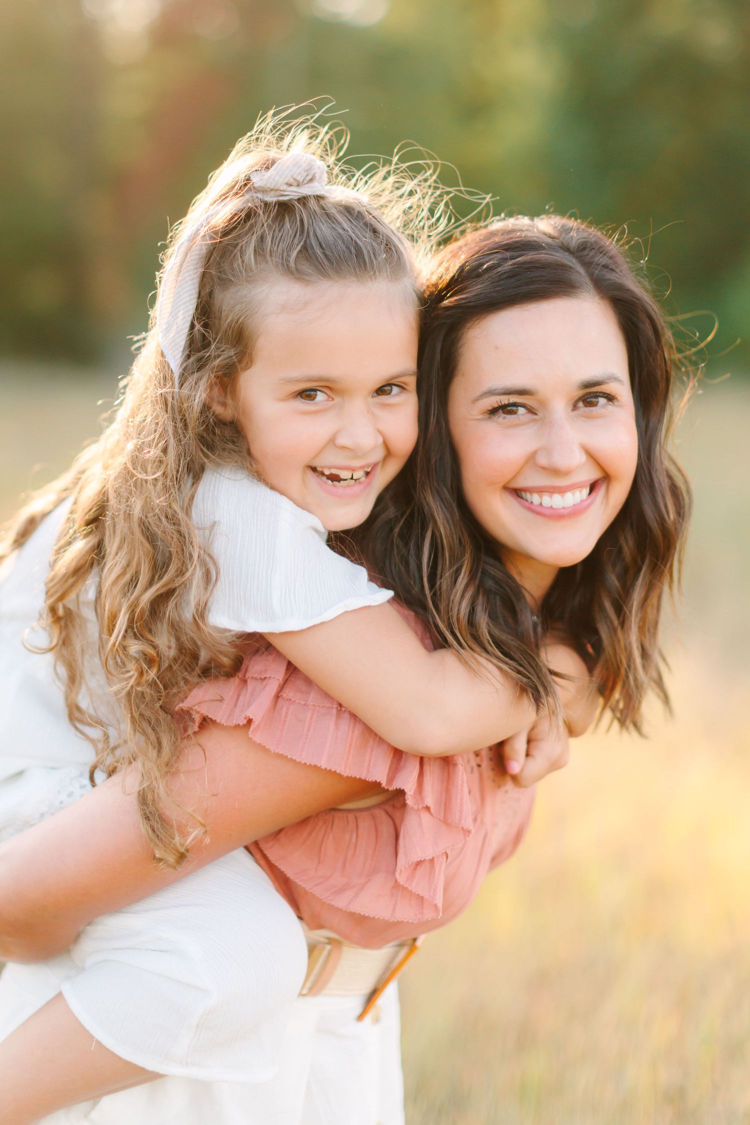 A series of candid outdoor portraits showing joyful embraces and genuine smiles in warm golden sunlight.
