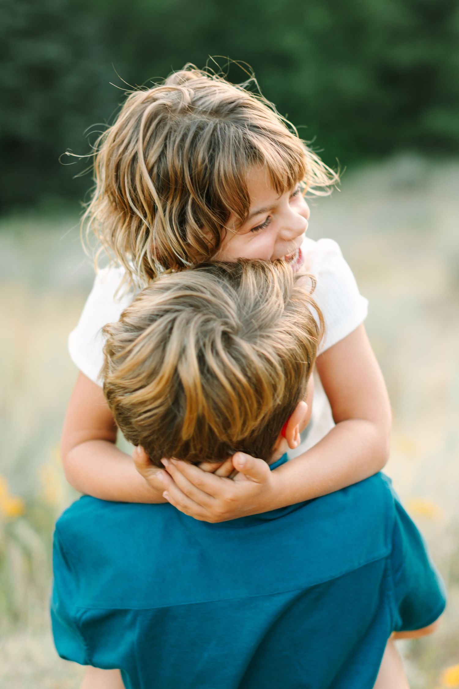 A sequence of tender embraces captured in a series of photos showing two people hugging against a soft green background.
