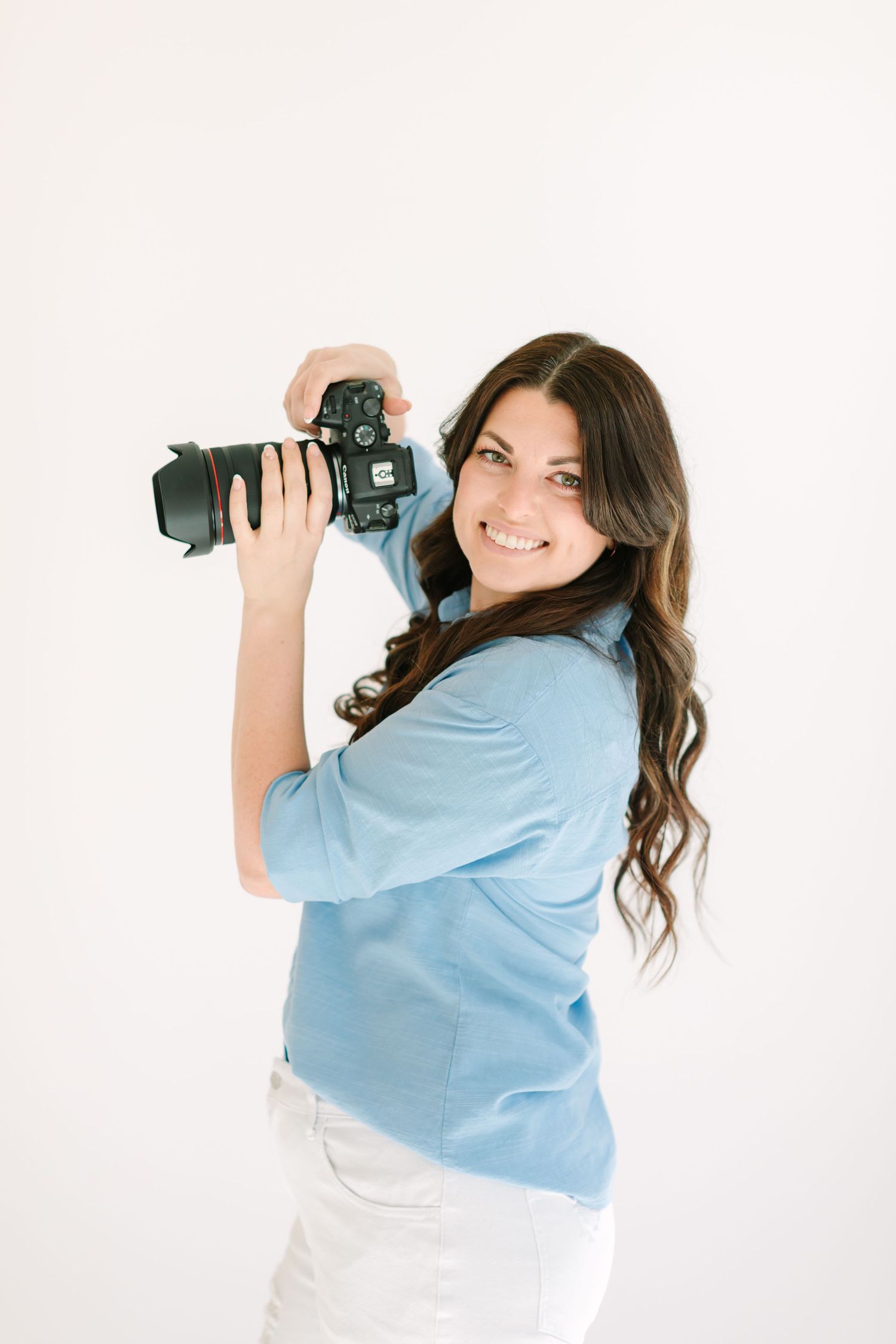 Professional photographer in light blue shirt holding DSLR camera in three dynamic poses against white background.