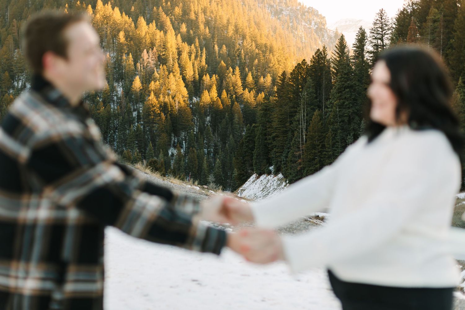 A series of photos showing a couple playing in the snow at sunset with golden mountain peaks in the background.
