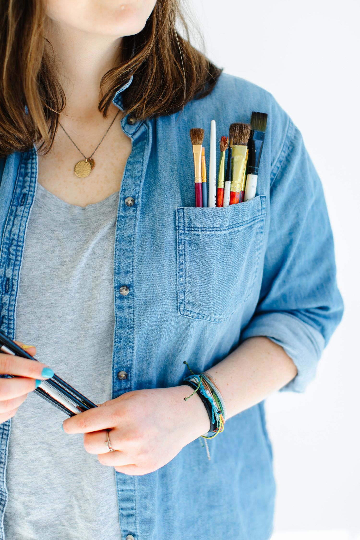 Close-up of denim shirt pocket filled with colorful markers and pens at White Space Studios in Provo, Utah in Utah County..