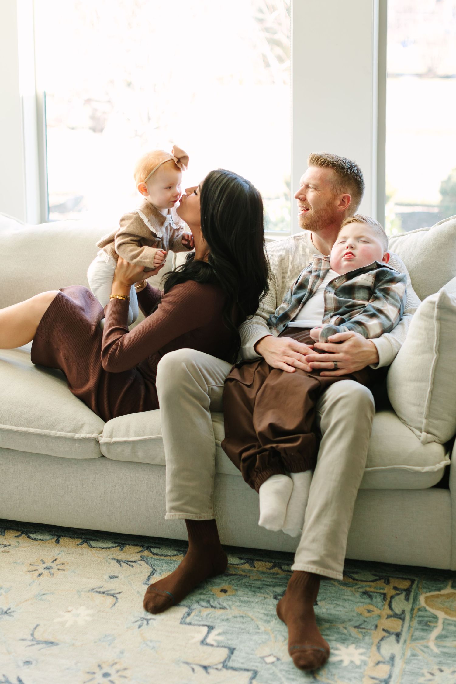 A sequence of candid lifestyle photos shows a family relaxing together on a white couch in a bright room.