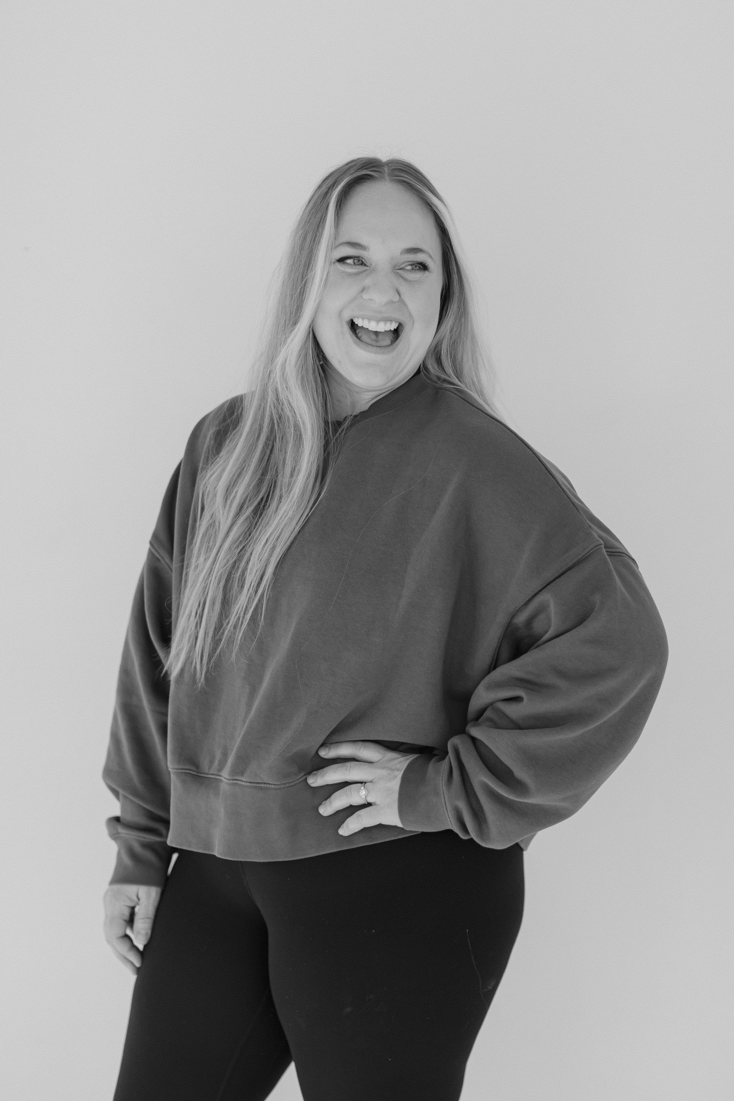 A series of black and white fashion portraits showing a person posing in a dark sweater and pants against a light background.
