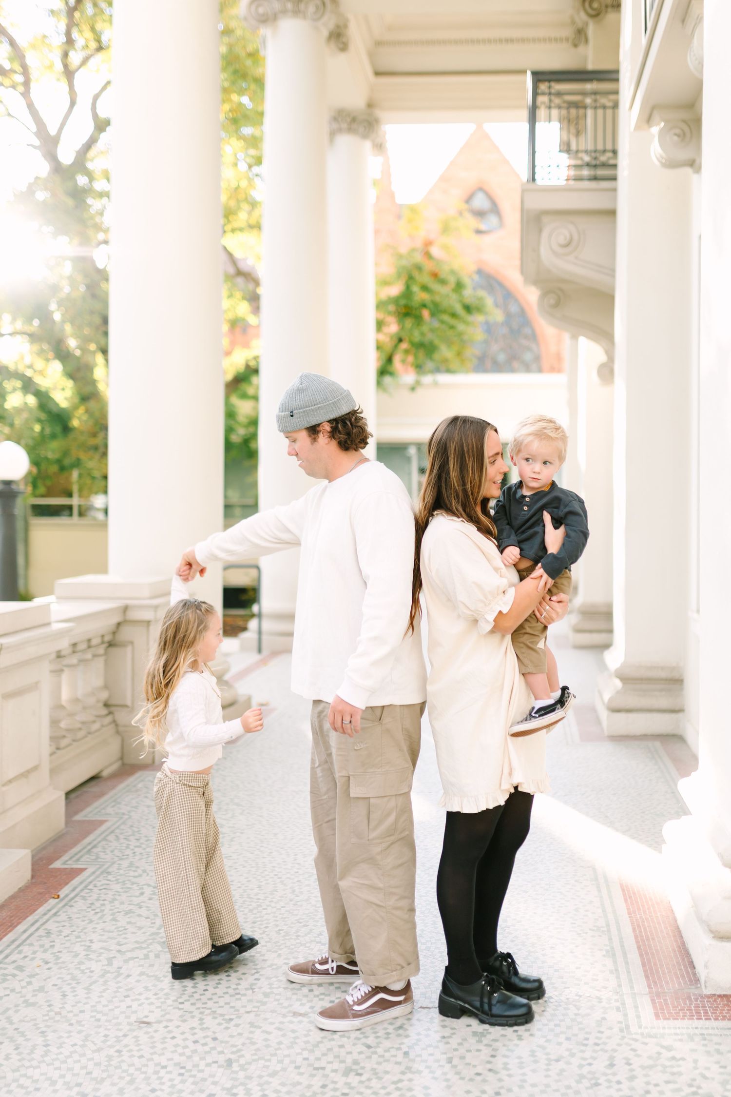 A young family plays together at the beautiful Monson Building in Salt Lake City, Utah.