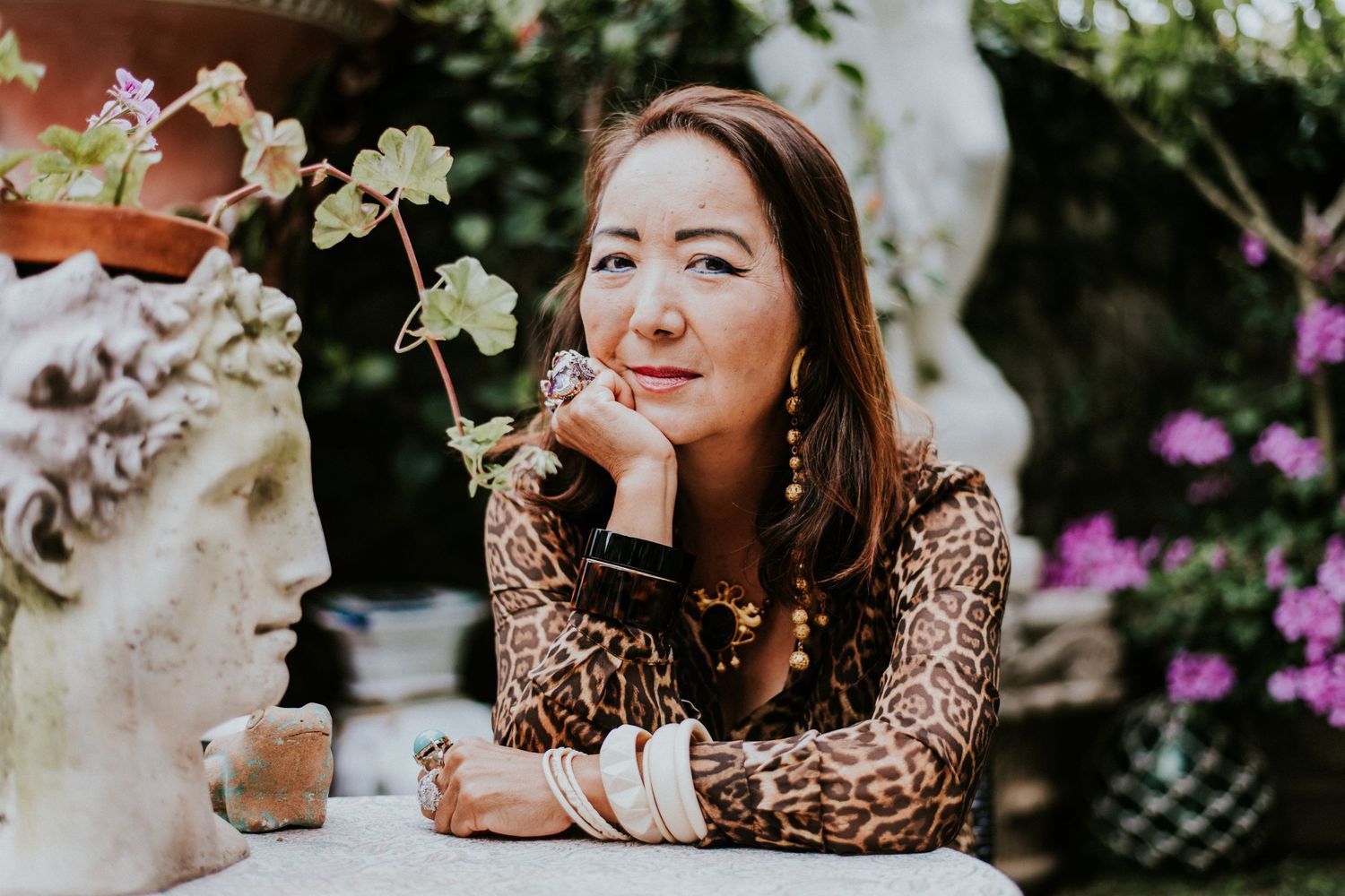 Creative lifestyle headshot of woman in garden setting in Los Angeles, styled portrait with natural greenery background.