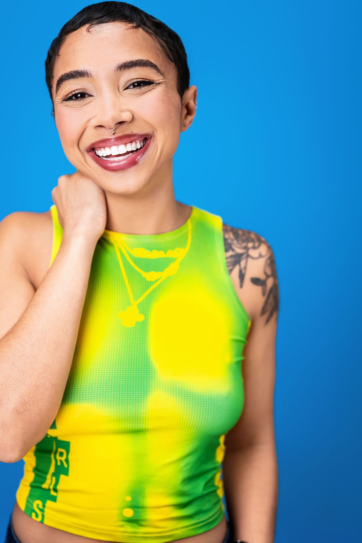 Confident female actor headshot with a bold tank top against a colorful backdrop photographed in Los Angeles