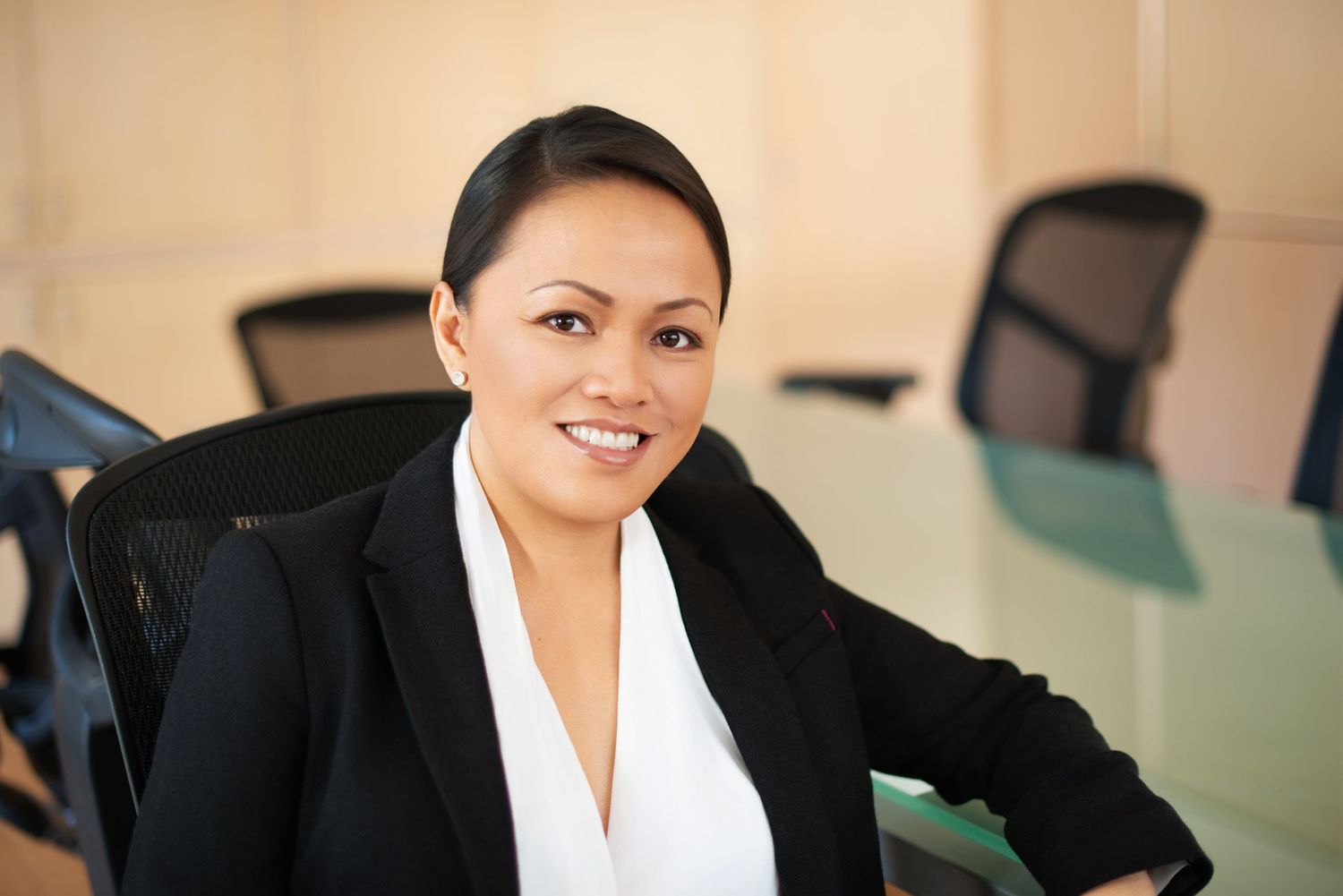 Professional team headshot of a woman in an office setting, photographed by Nice Headshots in Los Angeles