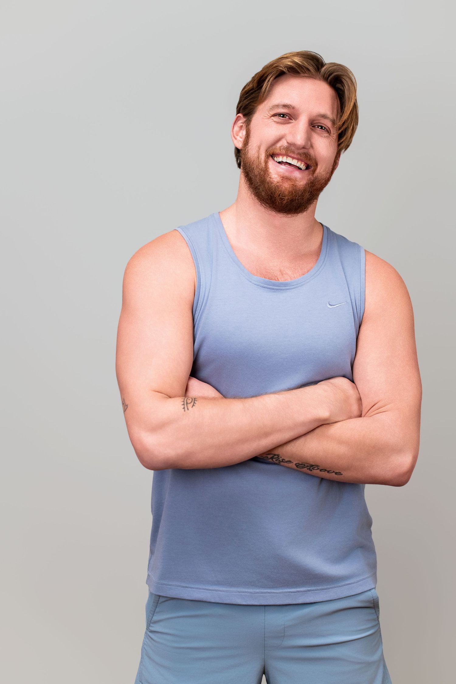Male model wearing a sleeveless top, photographed in studio against a gray backdrop for a professional modeling headshot in Los Angeles.