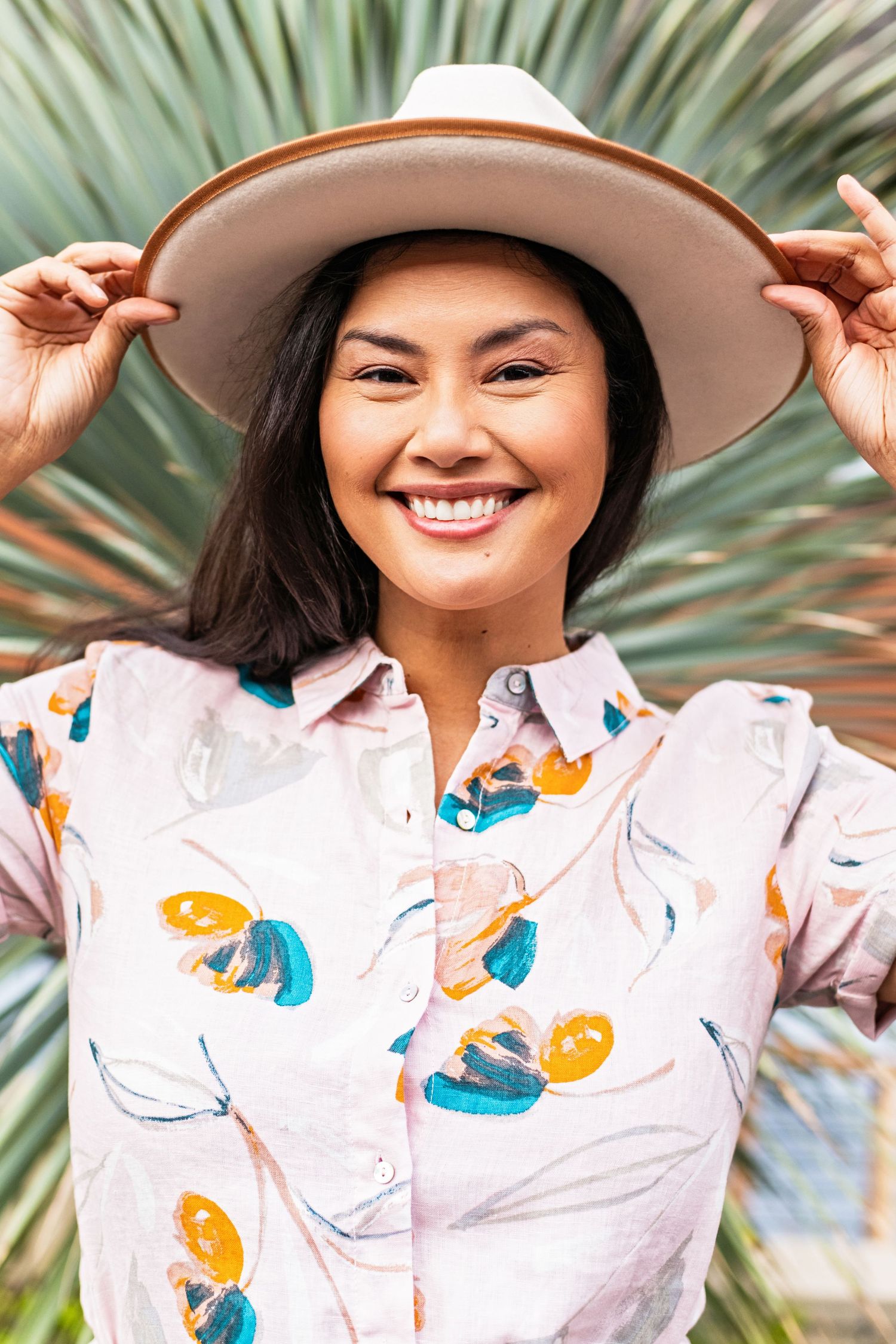 A lifestyle branding headshot with natural outdoor styling, showing a warm and approachable personal brand portrait.