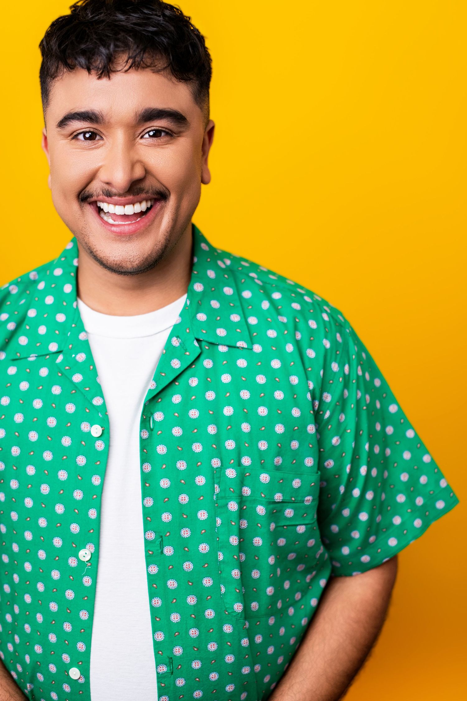 An expressive actor headshot with bright wardrobe and a colorful background, showing personality and castable energy.
