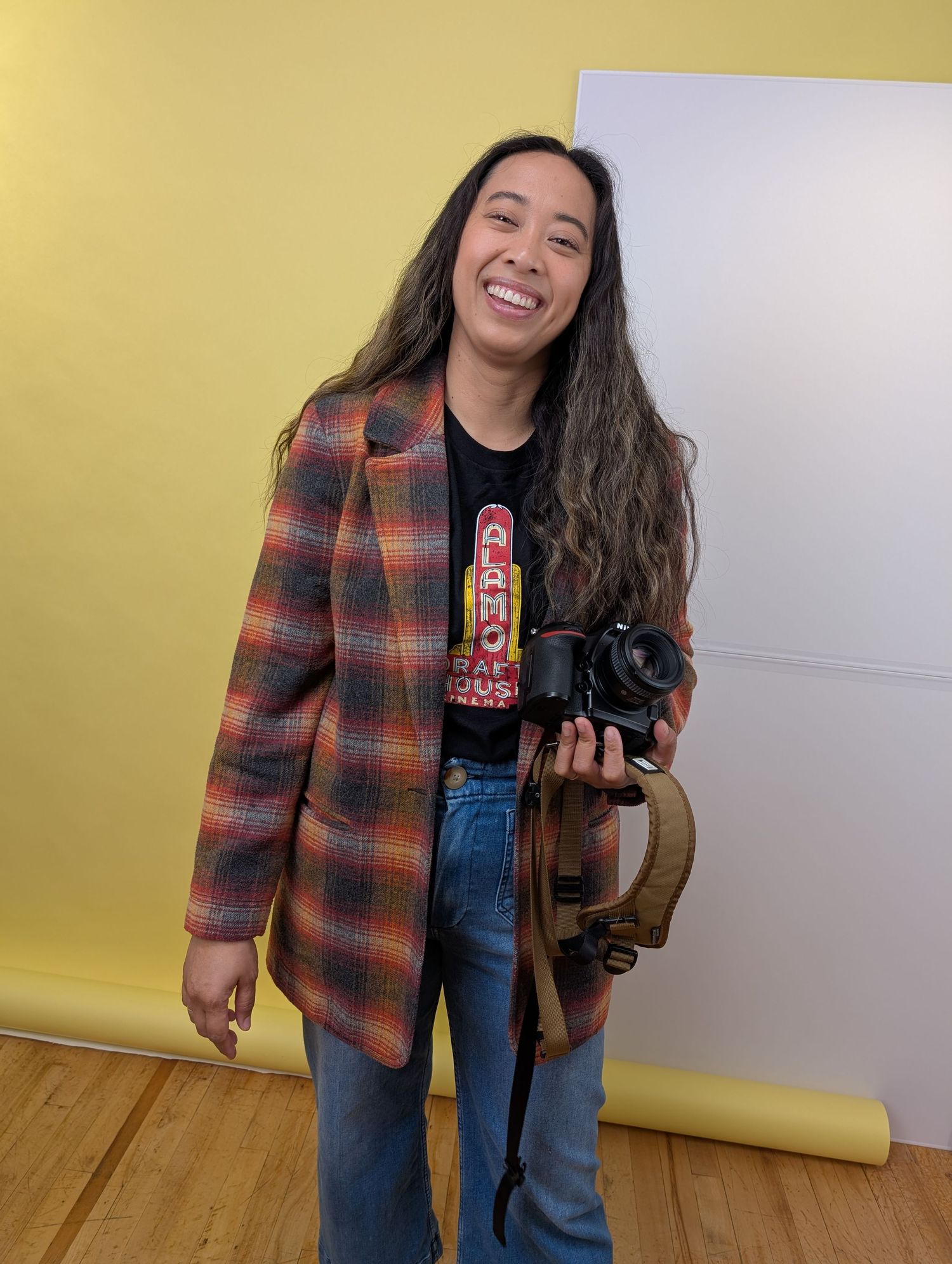 Los Angeles headshot photographer in studio holding camera preparing for a headshot session