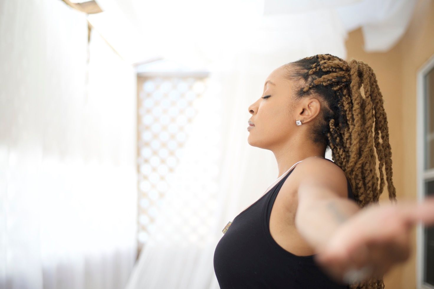 Lifestyle headshot of woman practicing mindful movement in Los Angeles, natural light portrait emphasizing calm and strength.