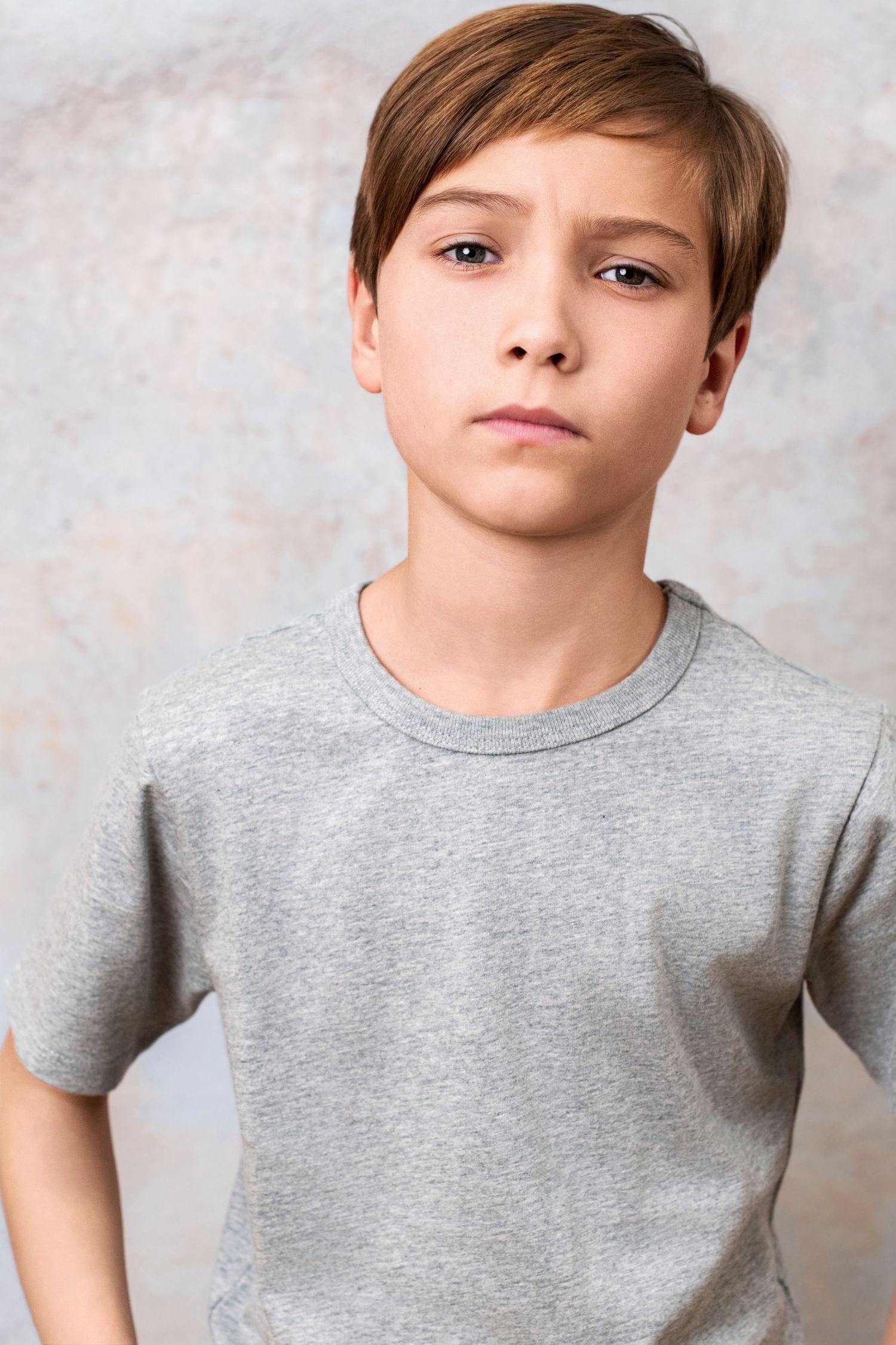 child actor headshot boy neutral grey shirt serious expression theatrical look