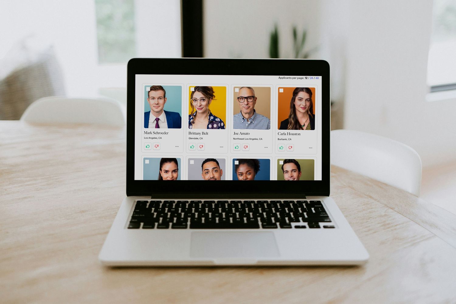 A laptop showing a casting site interface with standout actor headshots, illustrating how wardrobe impacts first impressions.