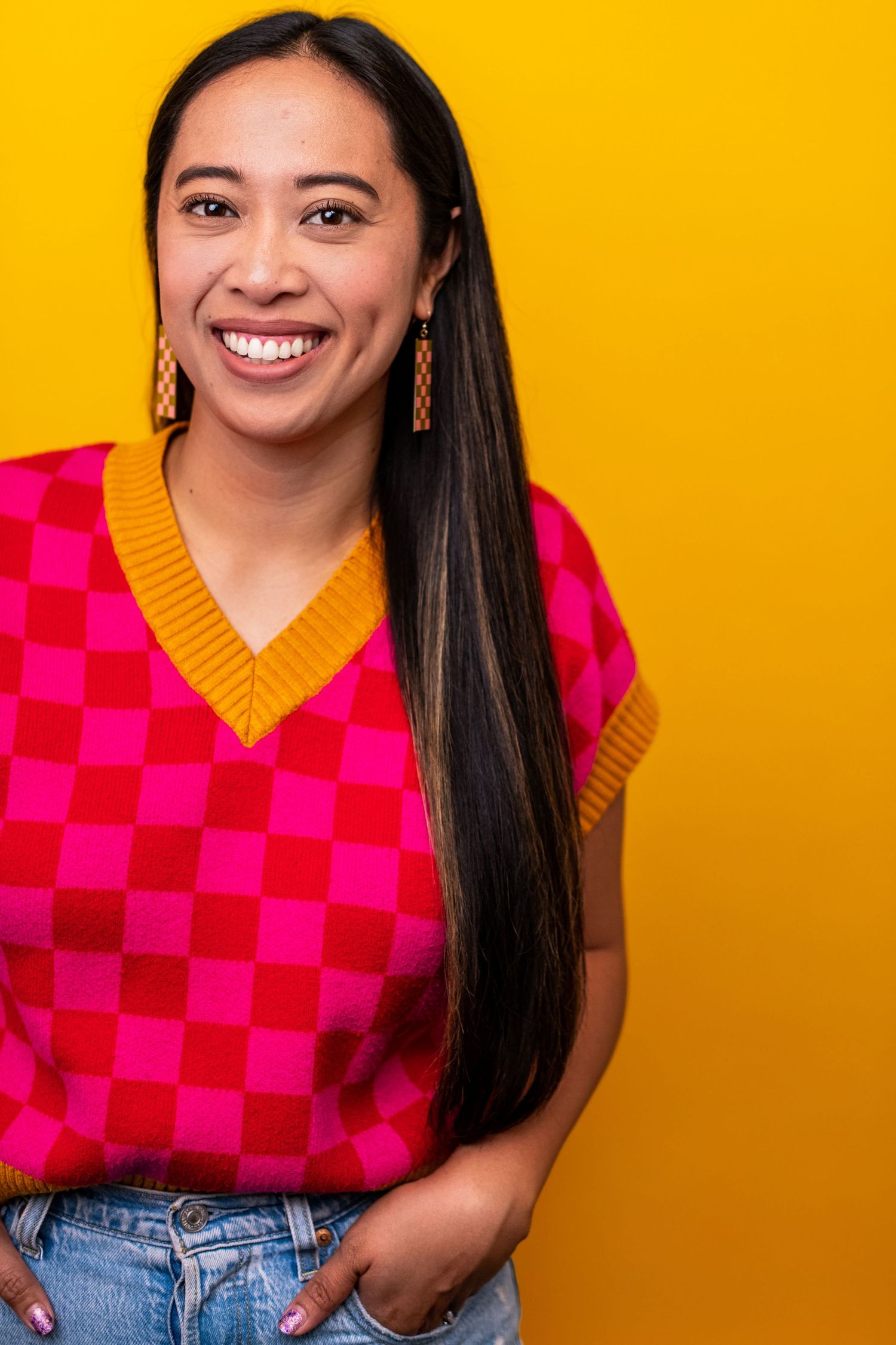 Alyssa Kearney, business owner and photographer at Nice Headshots, smiling in a colorful studio headshot in Los Angeles.