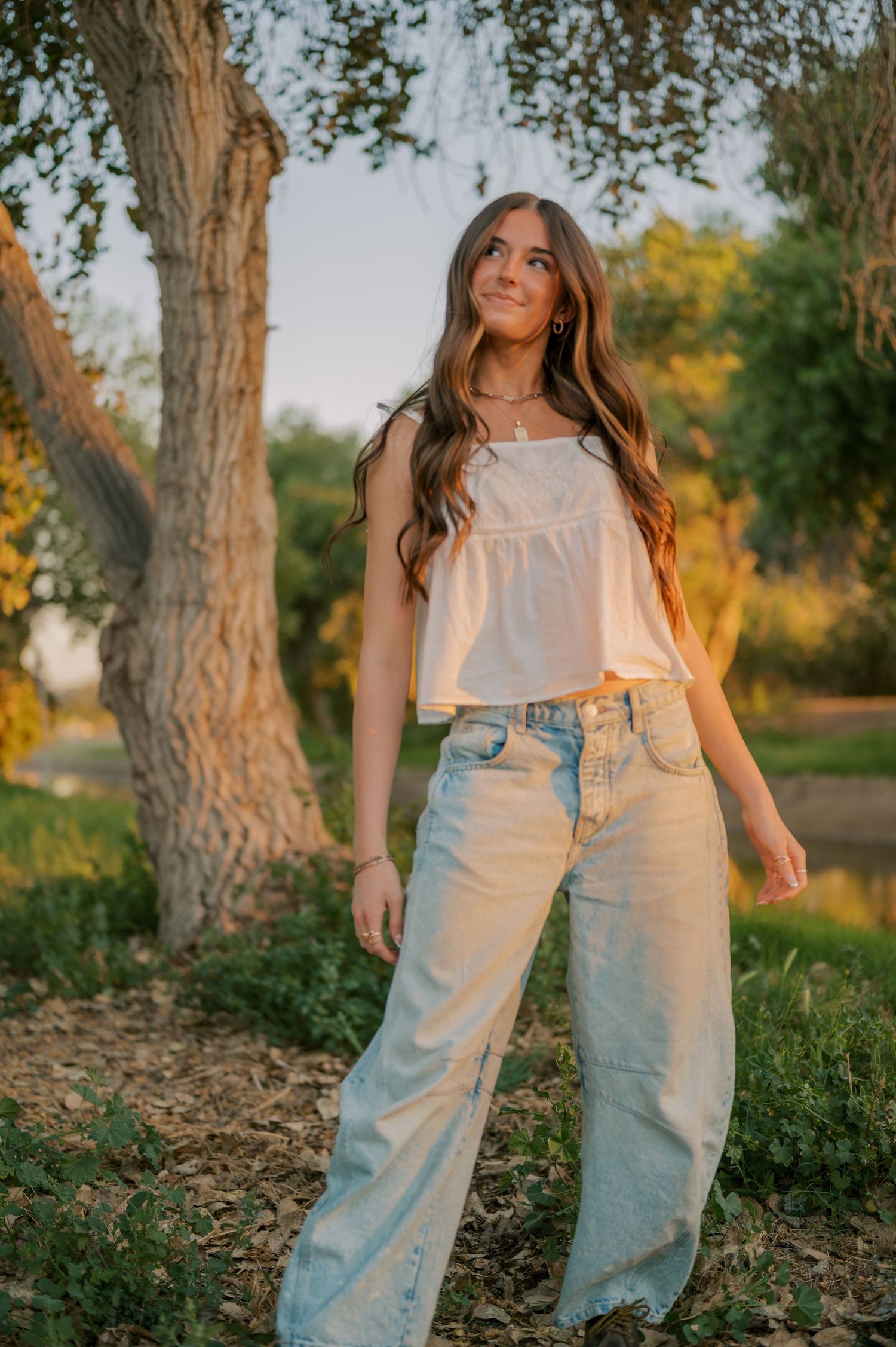Senior photos with soft, romantic light in a peaceful canal walkway