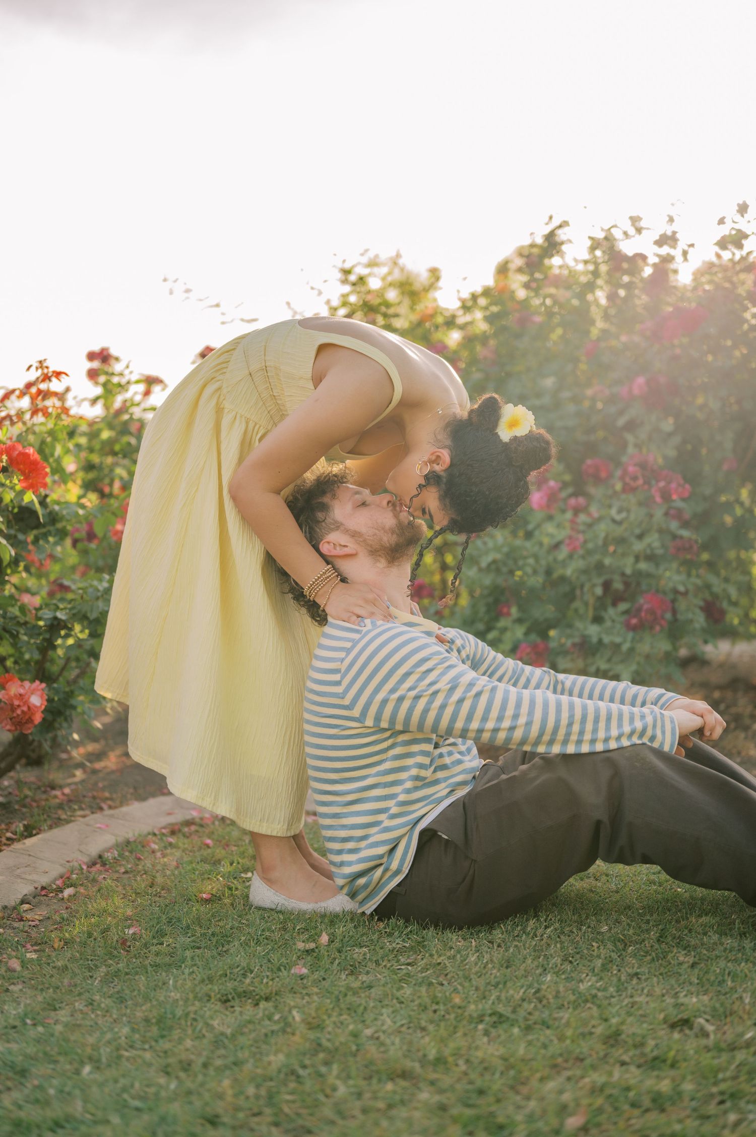 Romantic couple portrait in rose garden with soft natural light