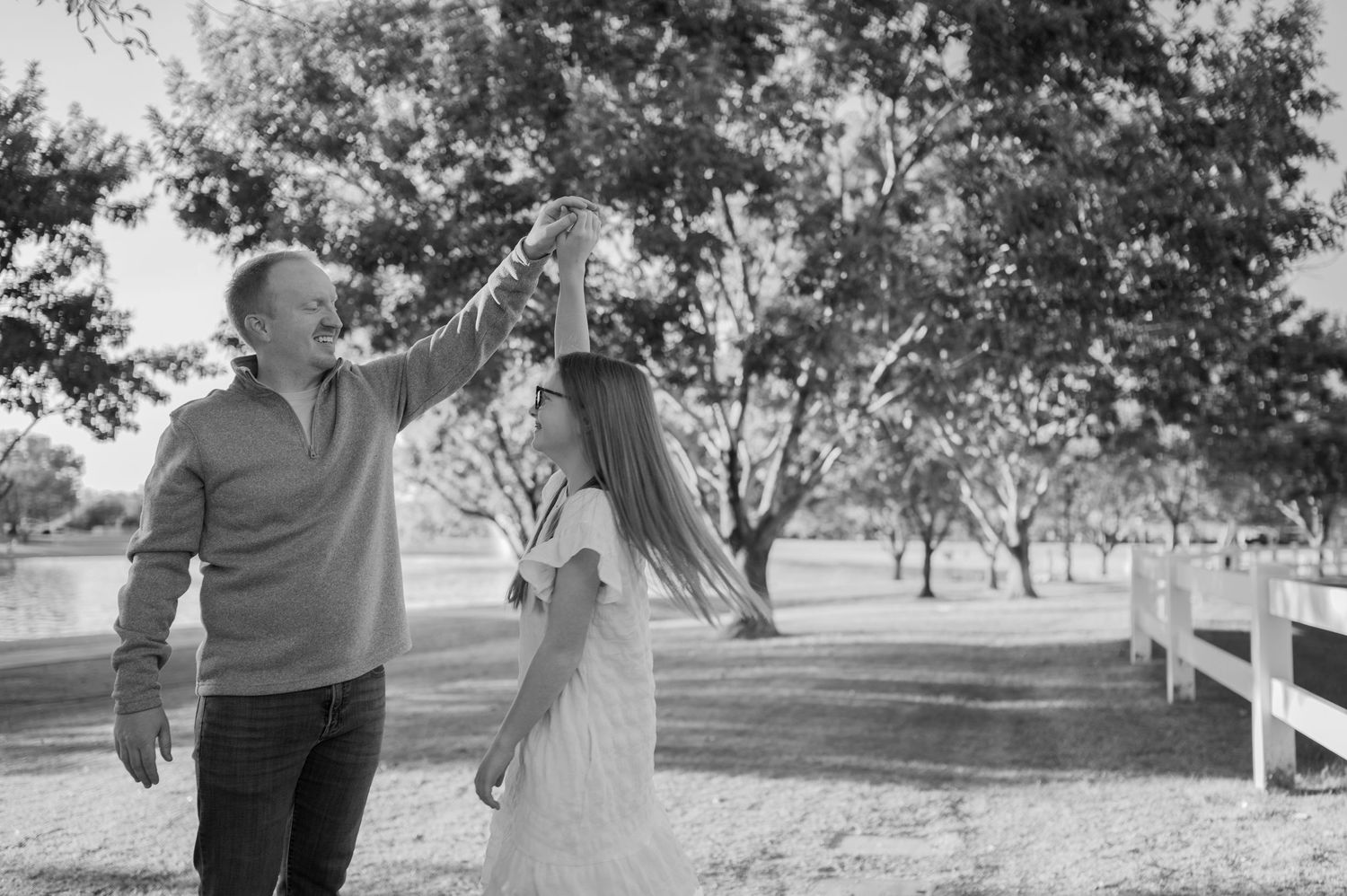 A couple in wedding attire dances together under trees in a romantic outdoor setting. Phoenix Arizona family photographer.