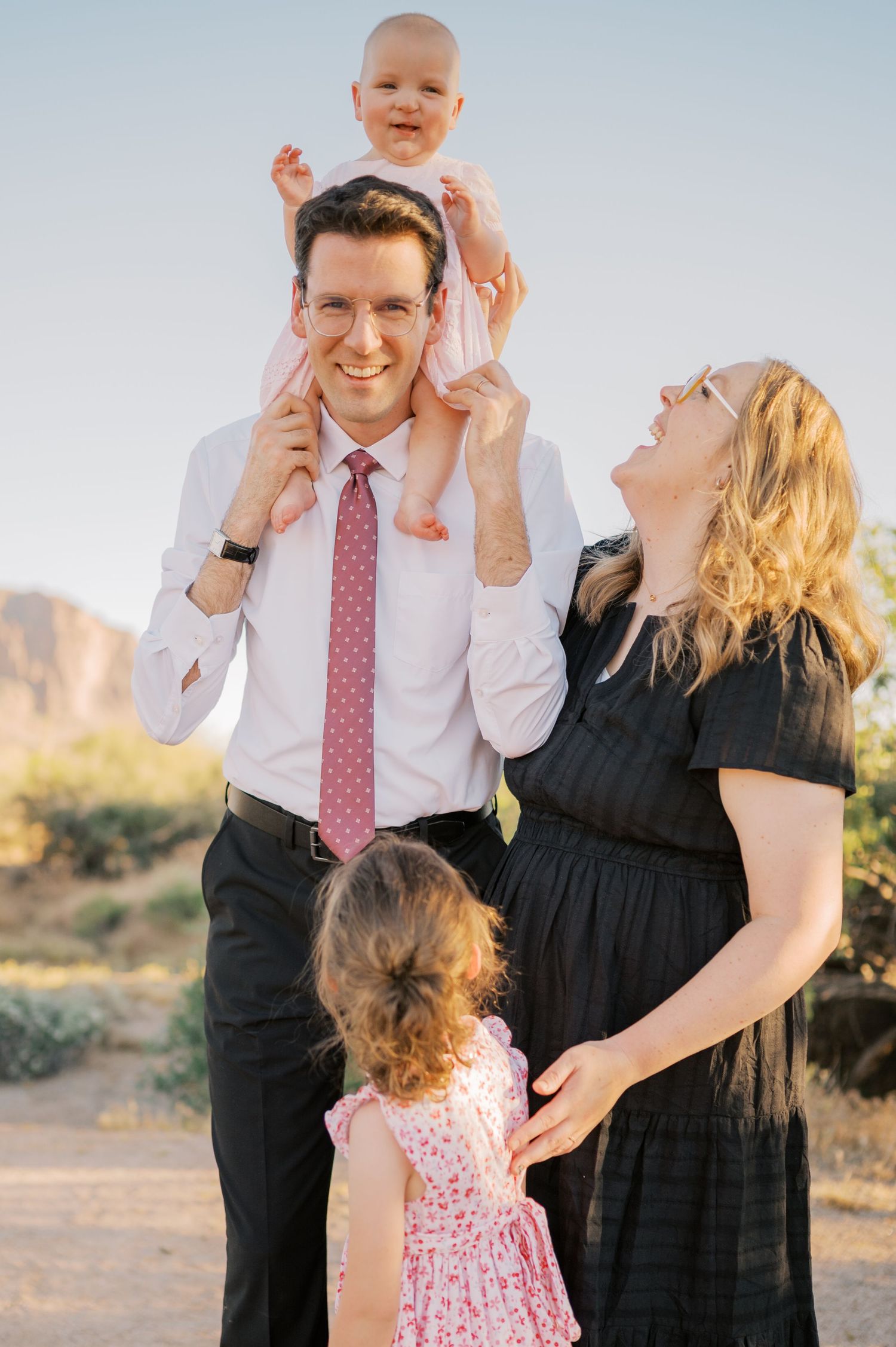 Family cuddling together during golden hour desert session