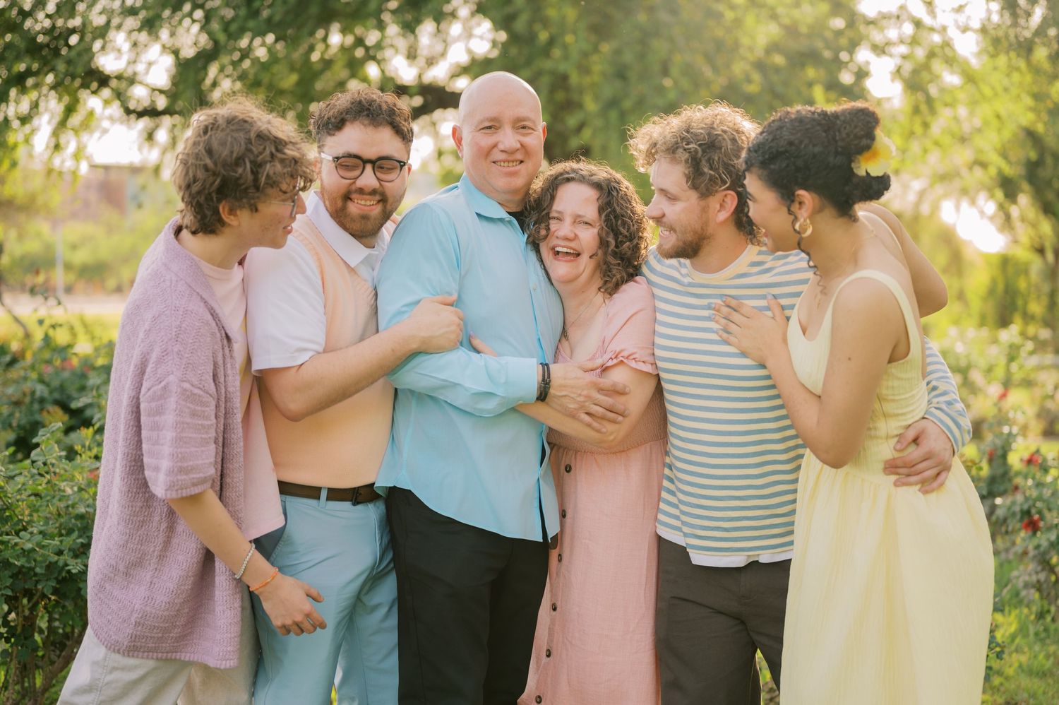 Family laughing together in a lush, colorful garden environment