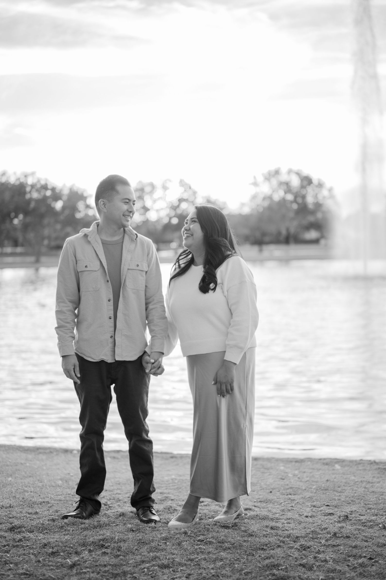 A romantic black and white photo series of a couple sharing tender moments by a lakeside.