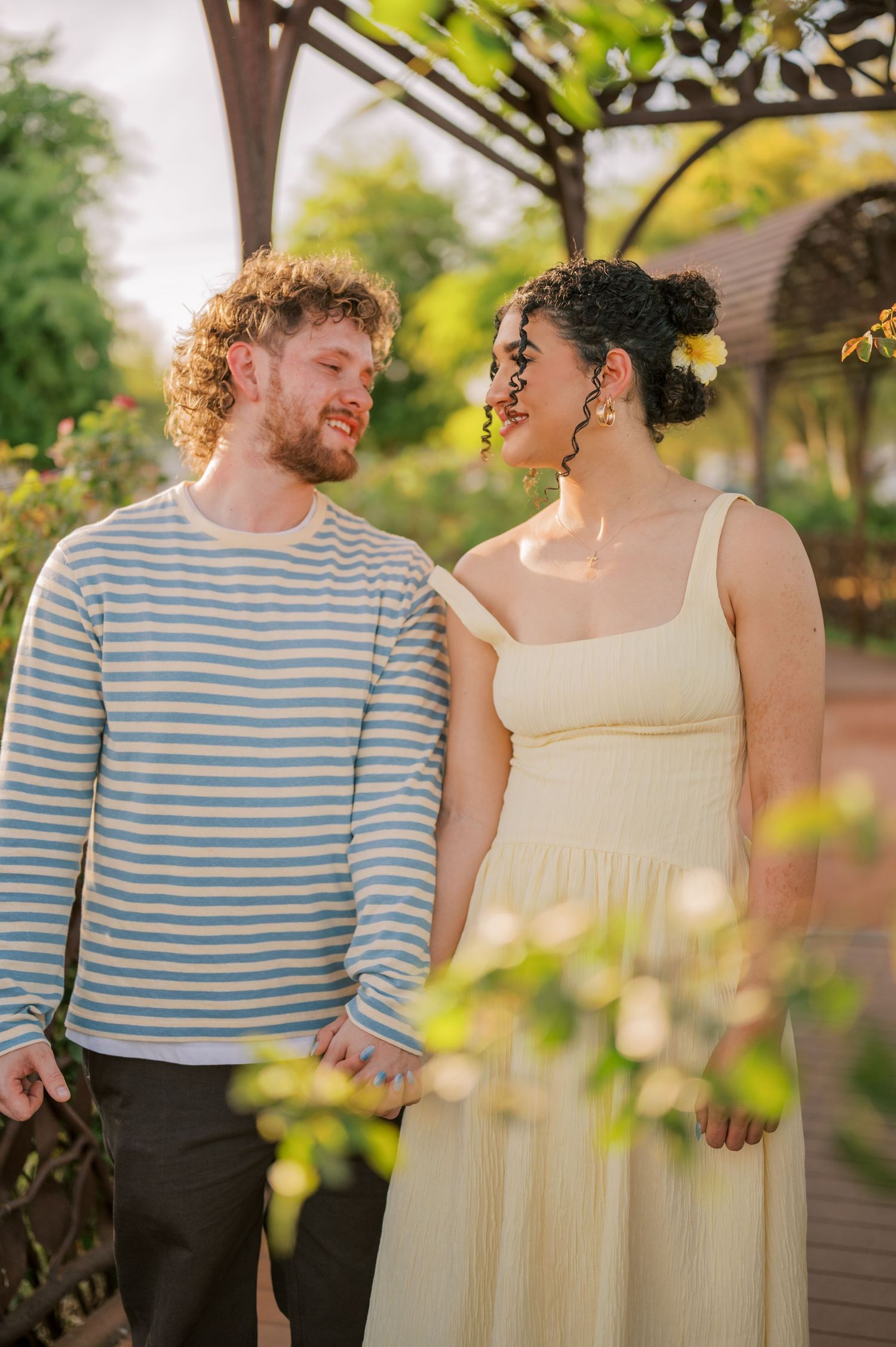 Romantic couple portrait in rose garden with soft natural light