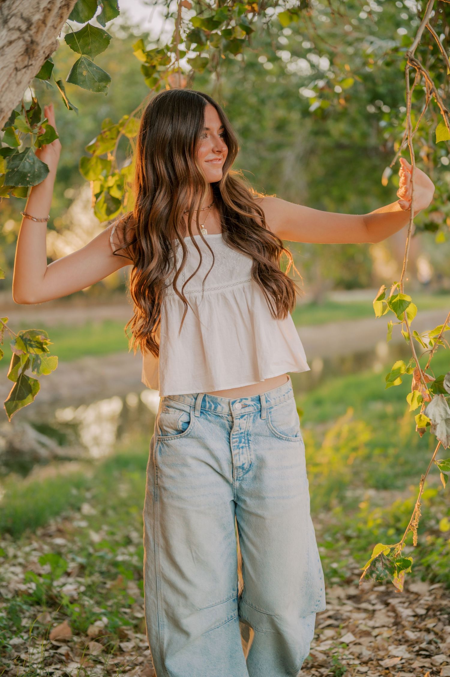 Candid senior moment captured in a whimsical outdoor canal setting