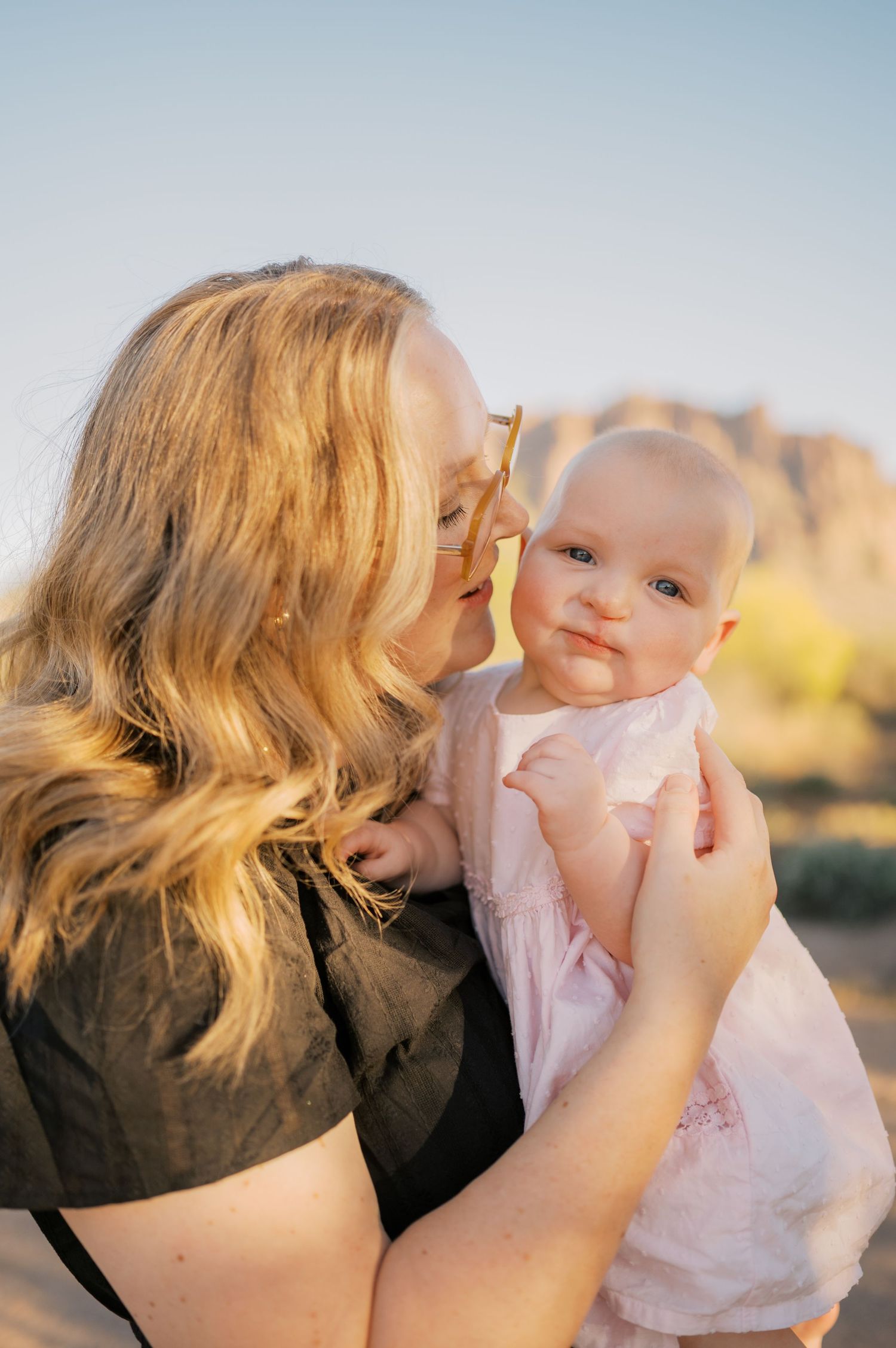 Mother holding child during golden hour Arizona desert photo session