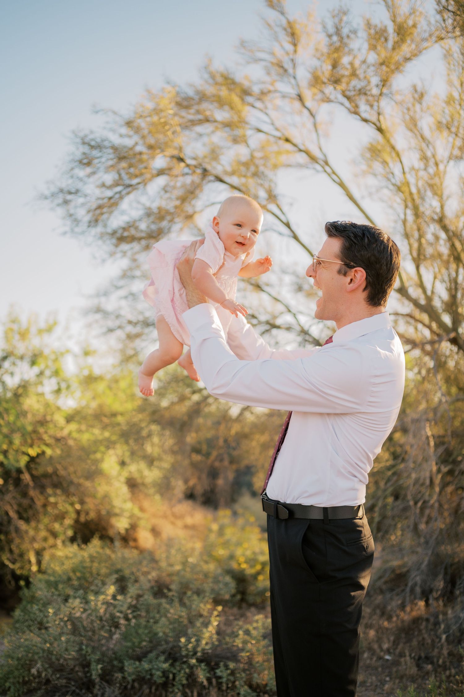 Father lifting child with mountains in background Phoenix family session