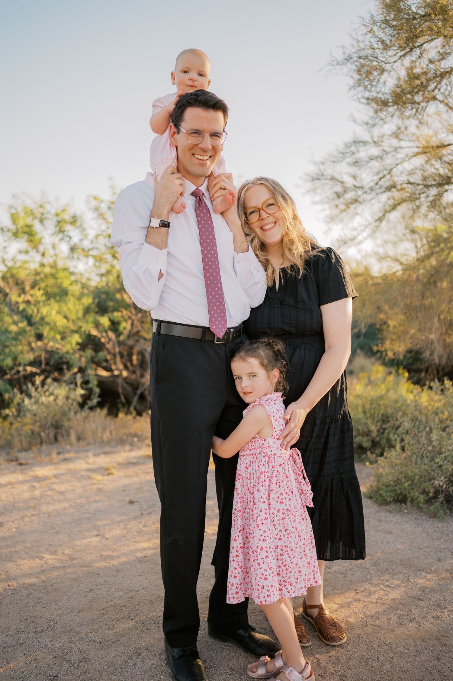 Family of four posing outdoors at golden hour in Arizona desert