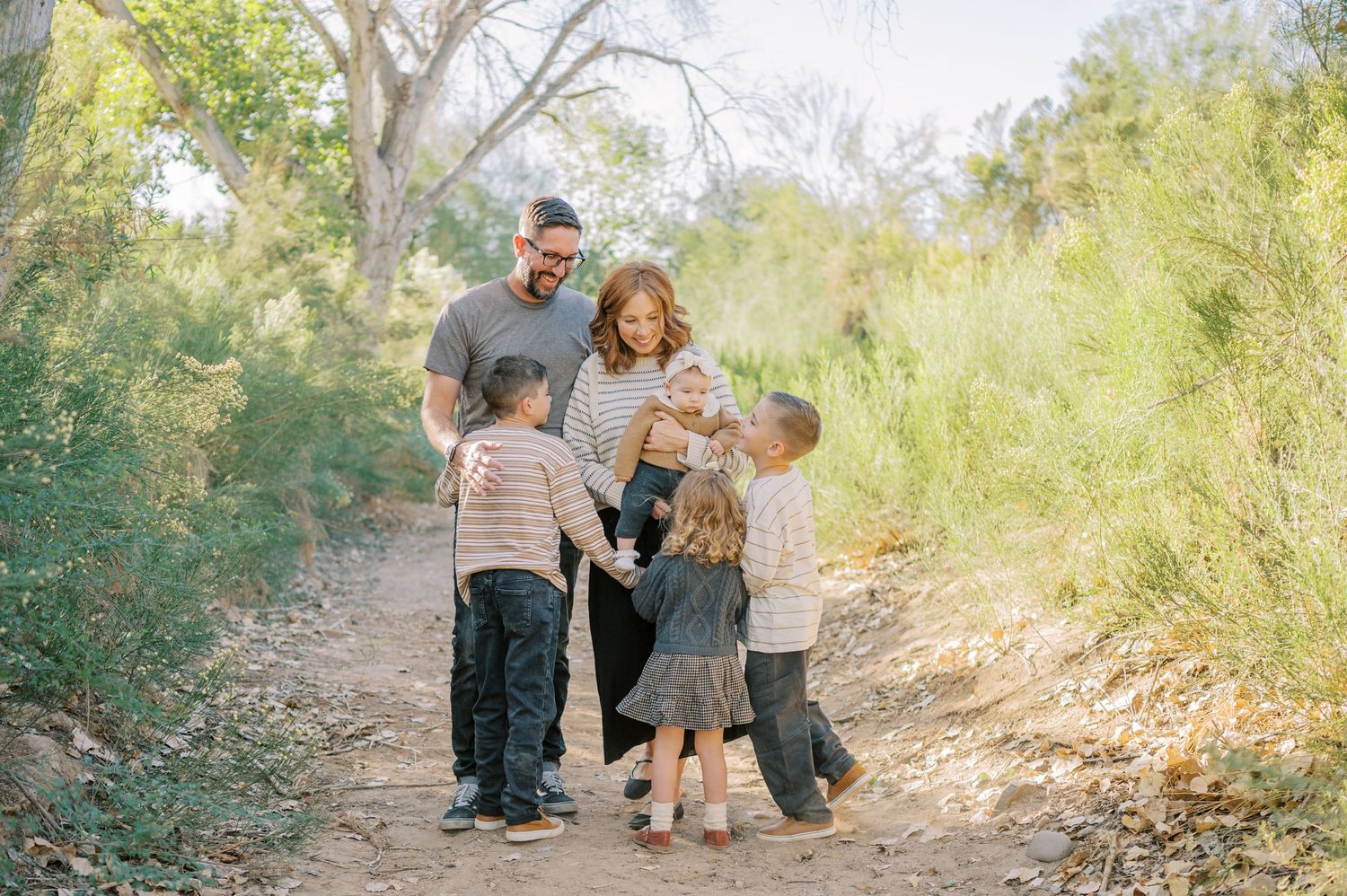 Luxury Gilbert Arizona family photography surrounded by lush greenery. A relaxed, stress-free experience that captures real connection.