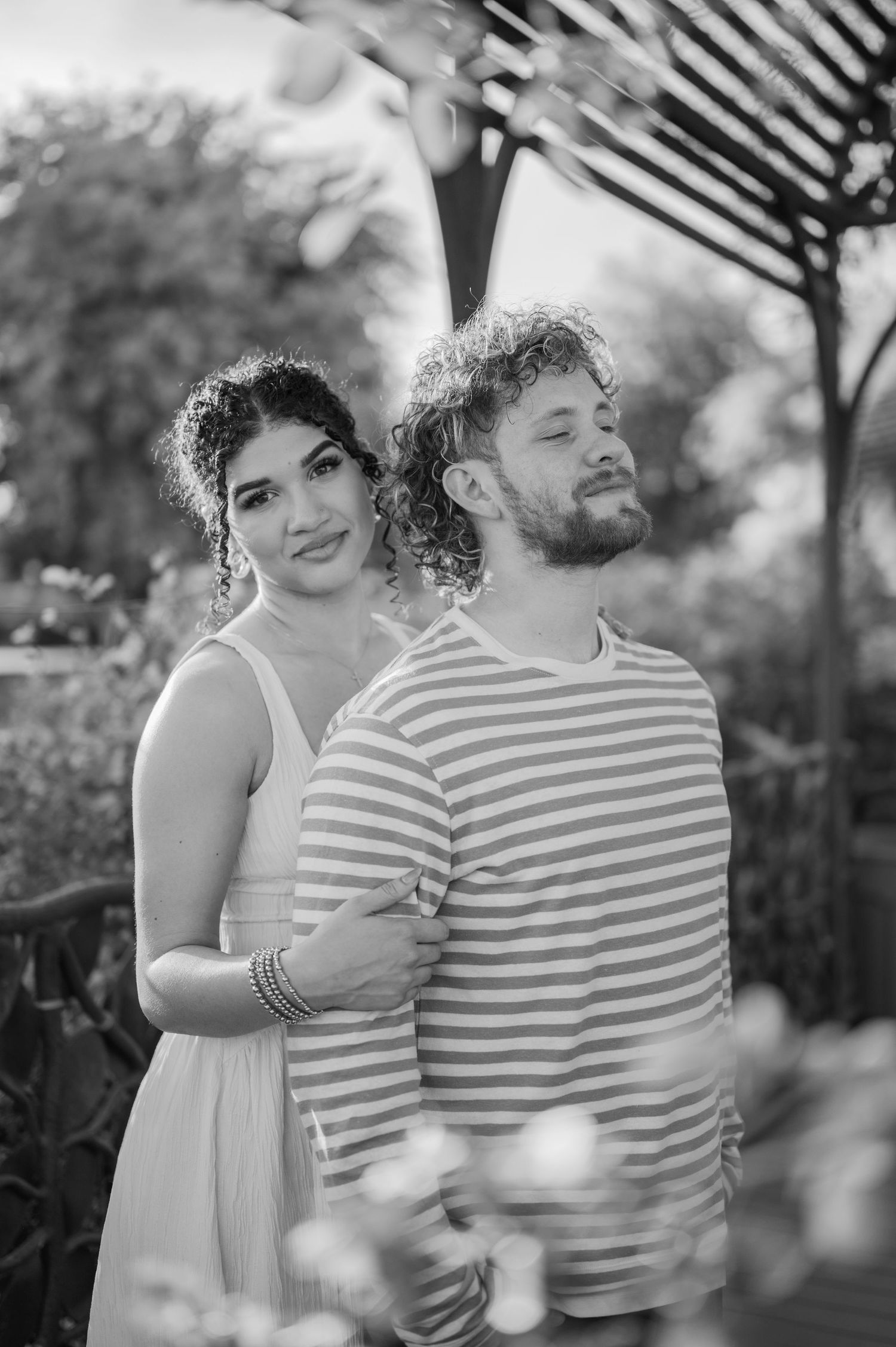 Romantic couple portrait in rose garden with soft natural light