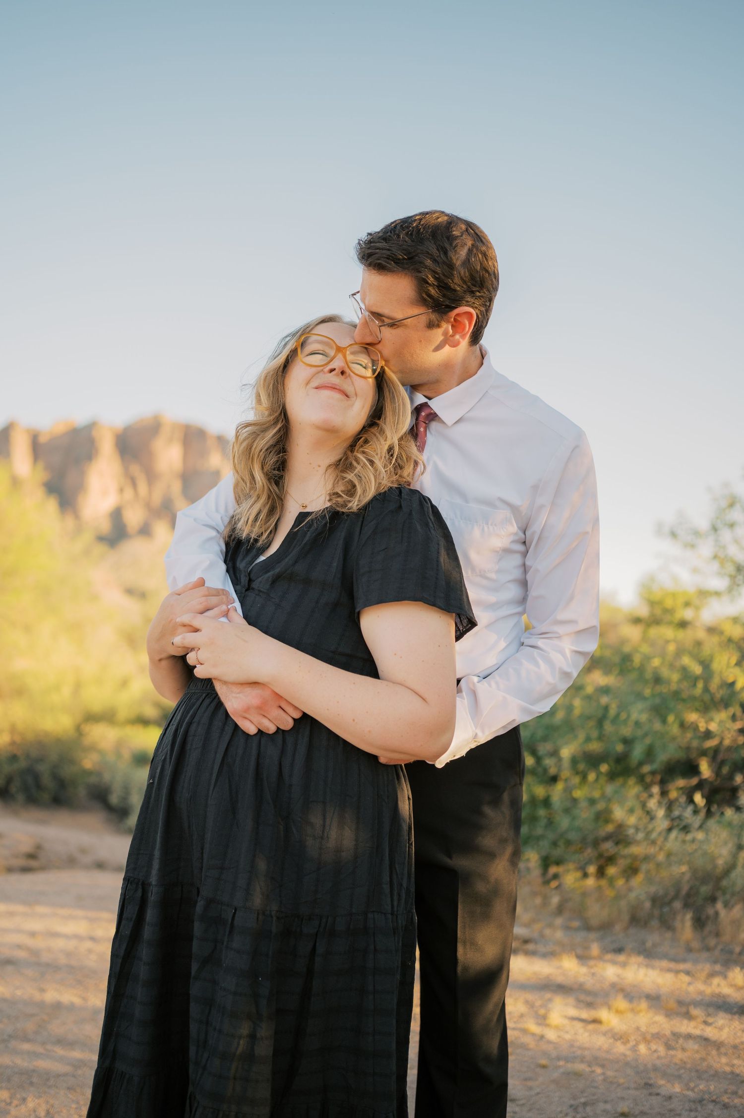Couple shares tender moment in desert, Superstition Mountains family photography