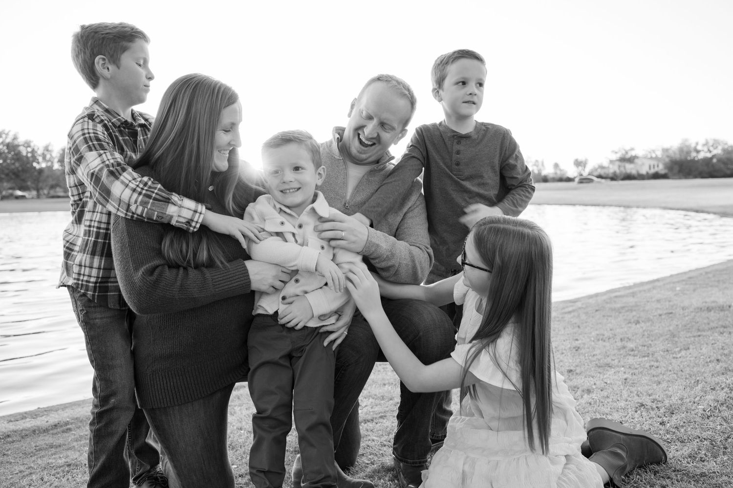 A series of black and white family photos showing tender moments between parents and children outdoors. Phoenix Arizona family photographer.