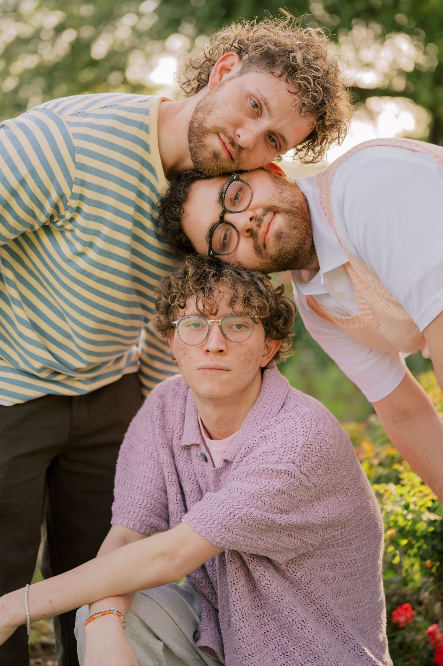 Candid extended family moment in a vibrant rose garden landscape