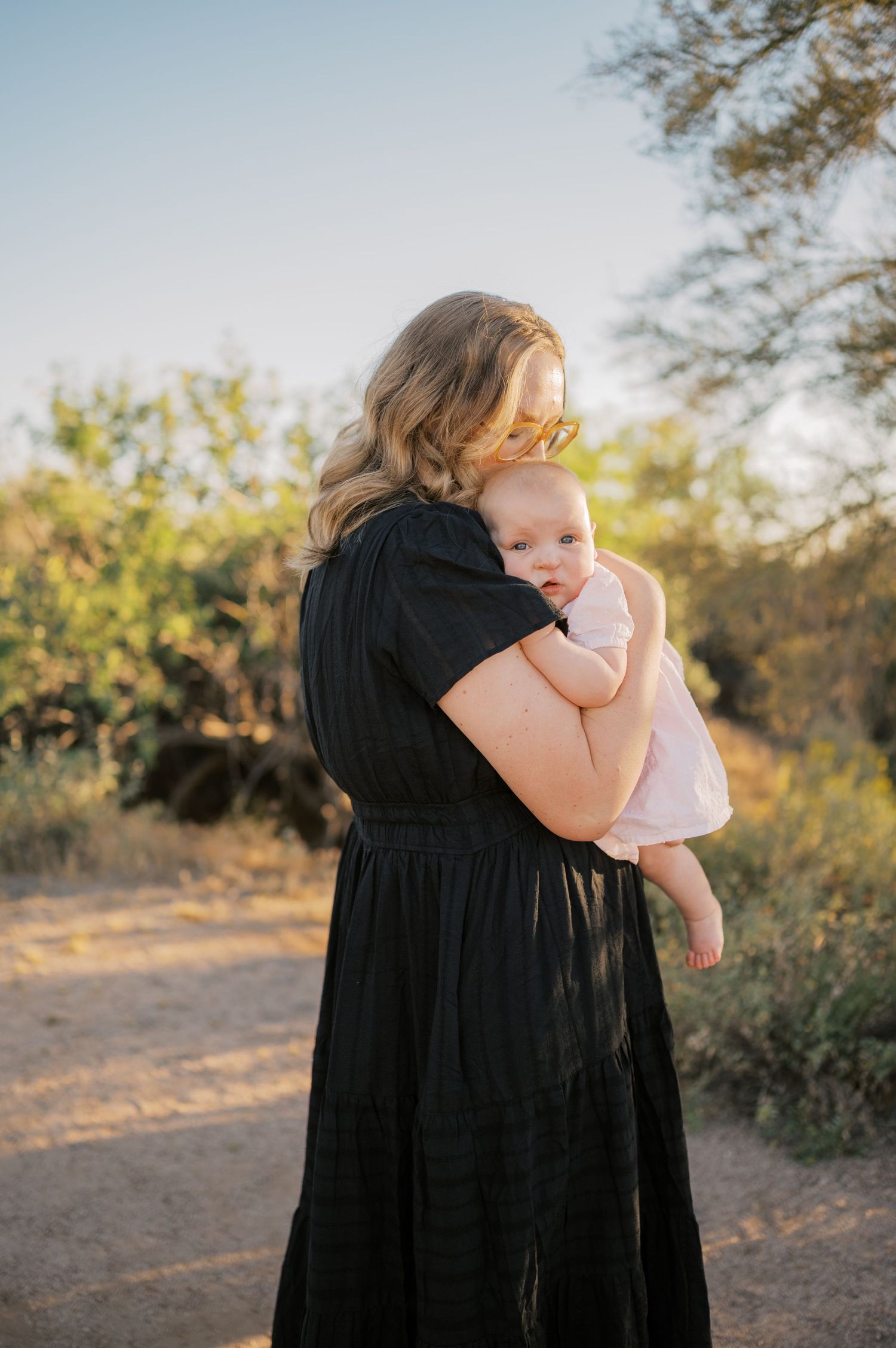 Mother holding child during golden hour Superstition Mountains photo session