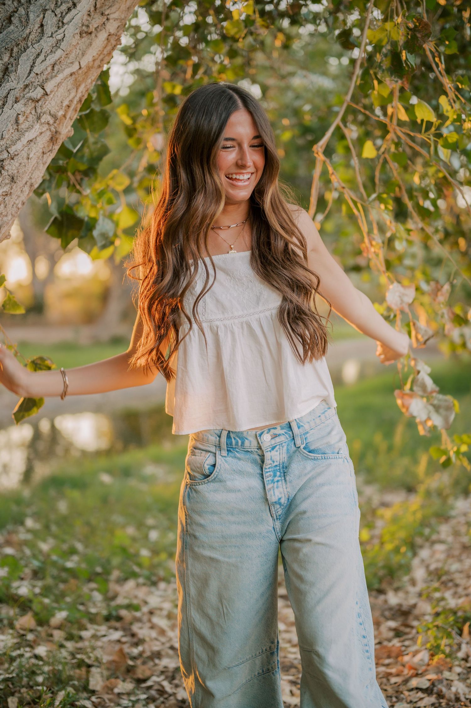 Senior smiling in soft golden light along a peaceful canal path