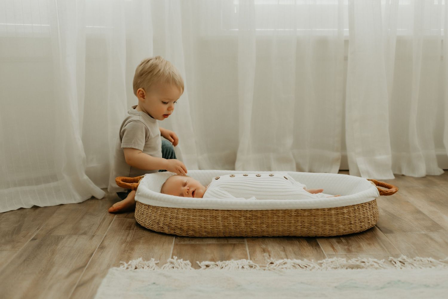 Natural light nursery setting with wicker bassinet and soft textiles.