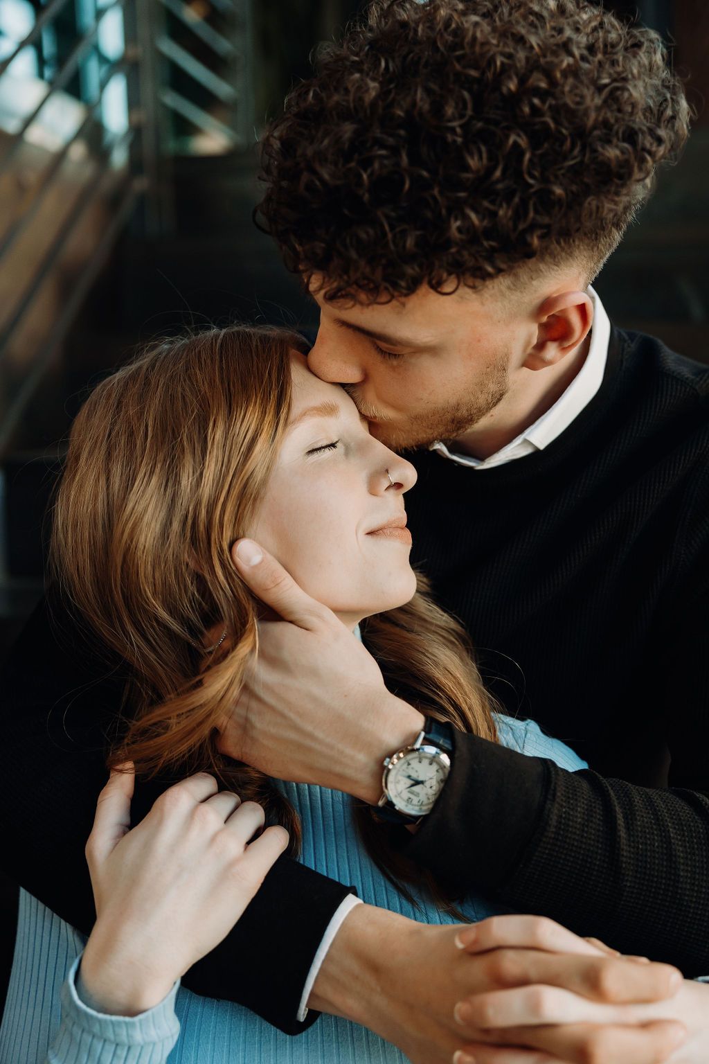 Intimate close-up portraits of couple sharing tender moments in dramatic lighting.