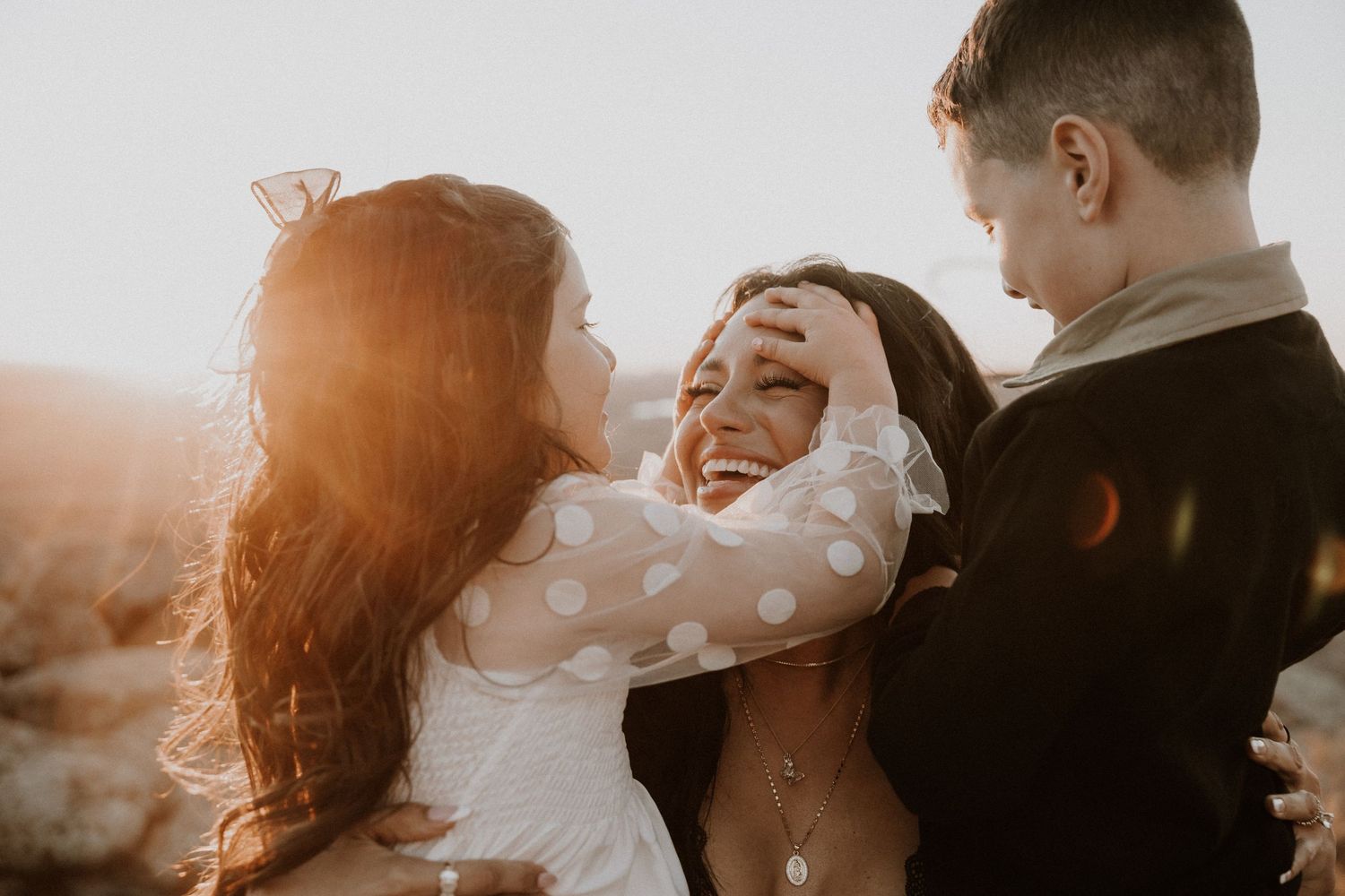 Couple embraces during golden hour sunset in a romantic outdoor photoshoot.