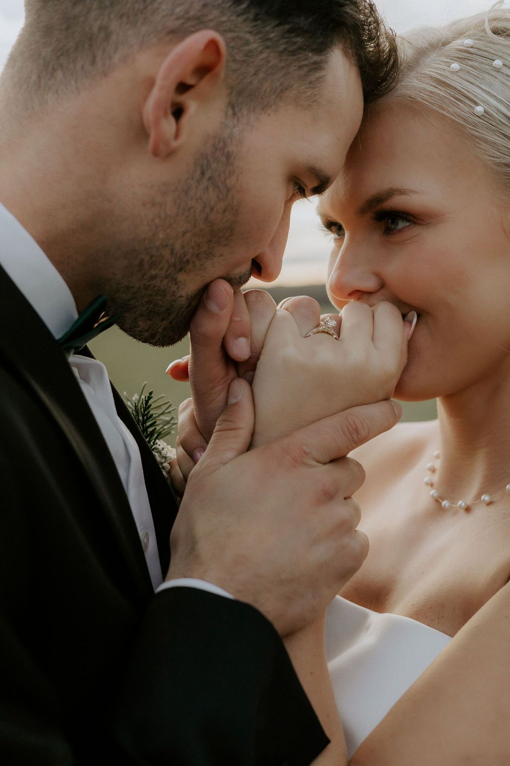 Intimate wedding portrait showing tender romantic moment between couple.